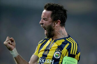 Fenerbahce's Gokhan Gonul celebrates a goal scored by Souza (not pictured) during the UEFA Europa League round of 32 first leg football match between Fenerbahce and Lokomotiv Moscow at Sukru Saracoglu Stadium, in Istanbul on February 16, 2016.  / AFP / ST