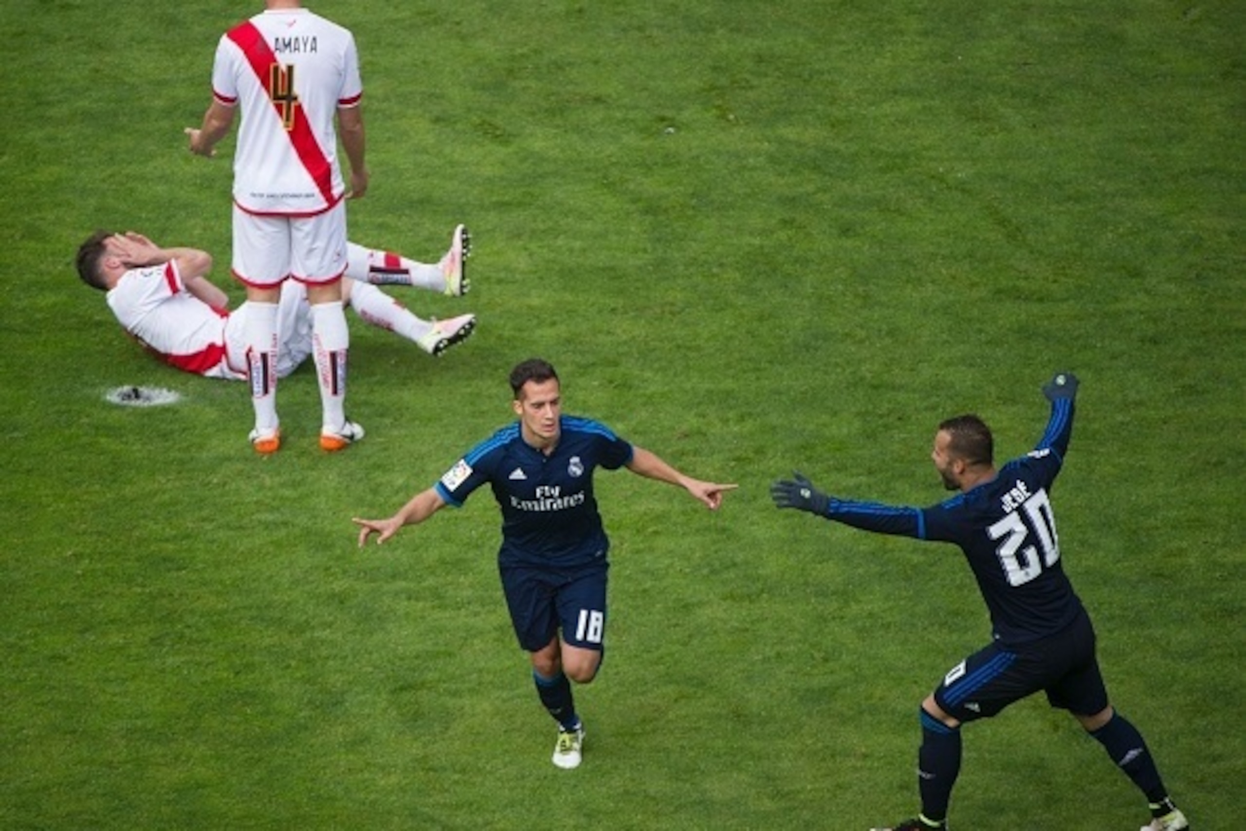 Real Madrid's midfielder Lucas Vazquez (2ndR) celebrates after scoring during the Spanish league football match Rayo Vallecano de Madrid vs Real Madrid CF at the Vallecas stadium in Madrid on April 23, 2016. / AFP / CURTO DE LA TORRE        (Photo credit 