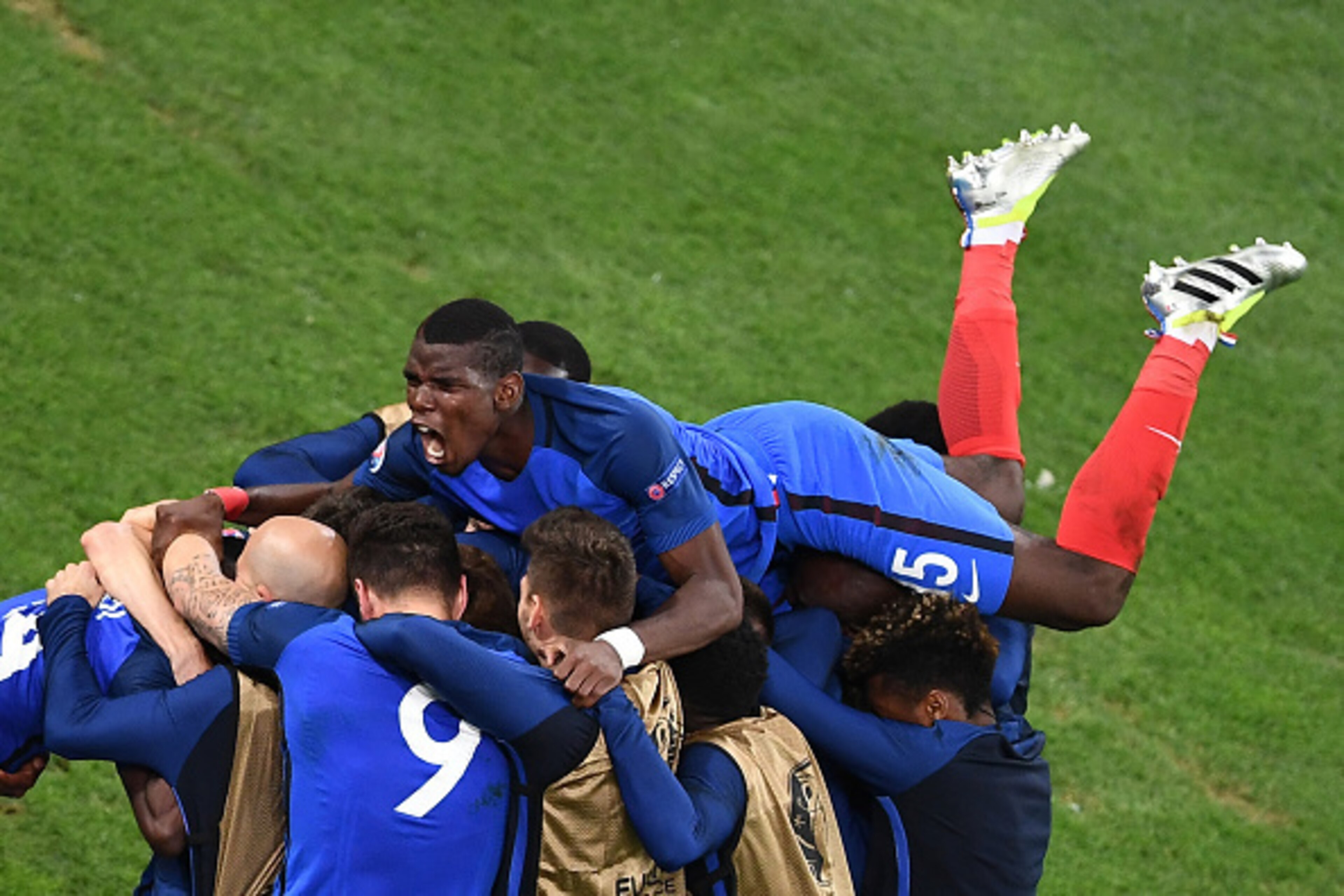 France's midfielder Paul Pogba (top) and his teammates celebrate after the team scored during the Euro 2016 group A football match between France and Albania at the Velodrome stadium in Marseille on June 15, 2016. / AFP / ANNE-CHRISTINE POUJOULAT ( France's midfielder Paul Pogba (top) and his teammates celebrate after the team scored during the Euro 2016 group A football match between France and Albania at the Velodrome stadium in Marseille on June 15, 2016. / AFP / ANNE-CHRISTINE POUJOULAT (