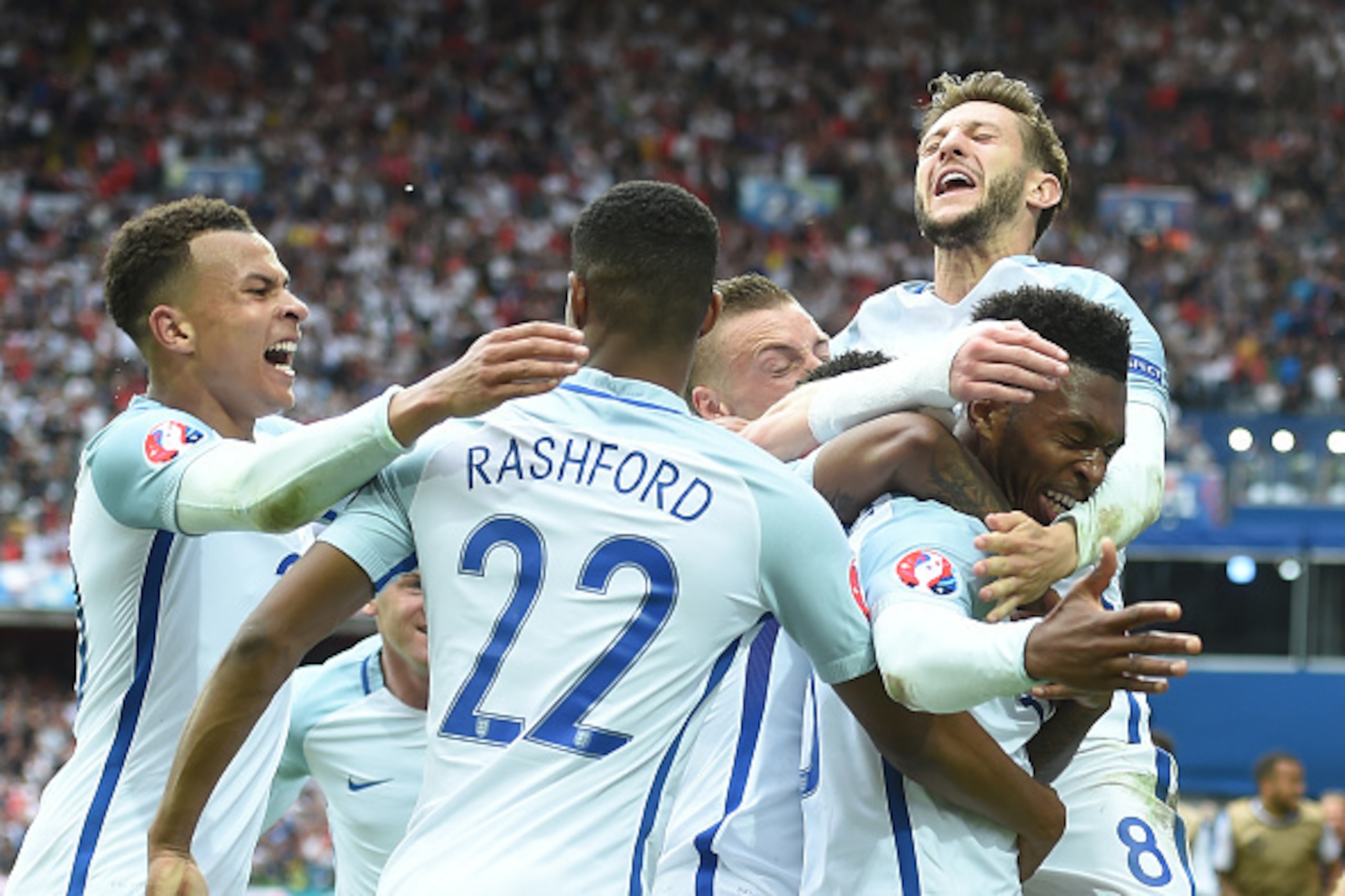 England's forward Daniel Sturridge (R) celebrates scoring the 2-1 goal with team mates during the Euro 2016 group B football match between England and Wales at the Bollaert-Delelis stadium in Lens on June 16, 2016.
England won the match 2-1. / AFP / PAUL 