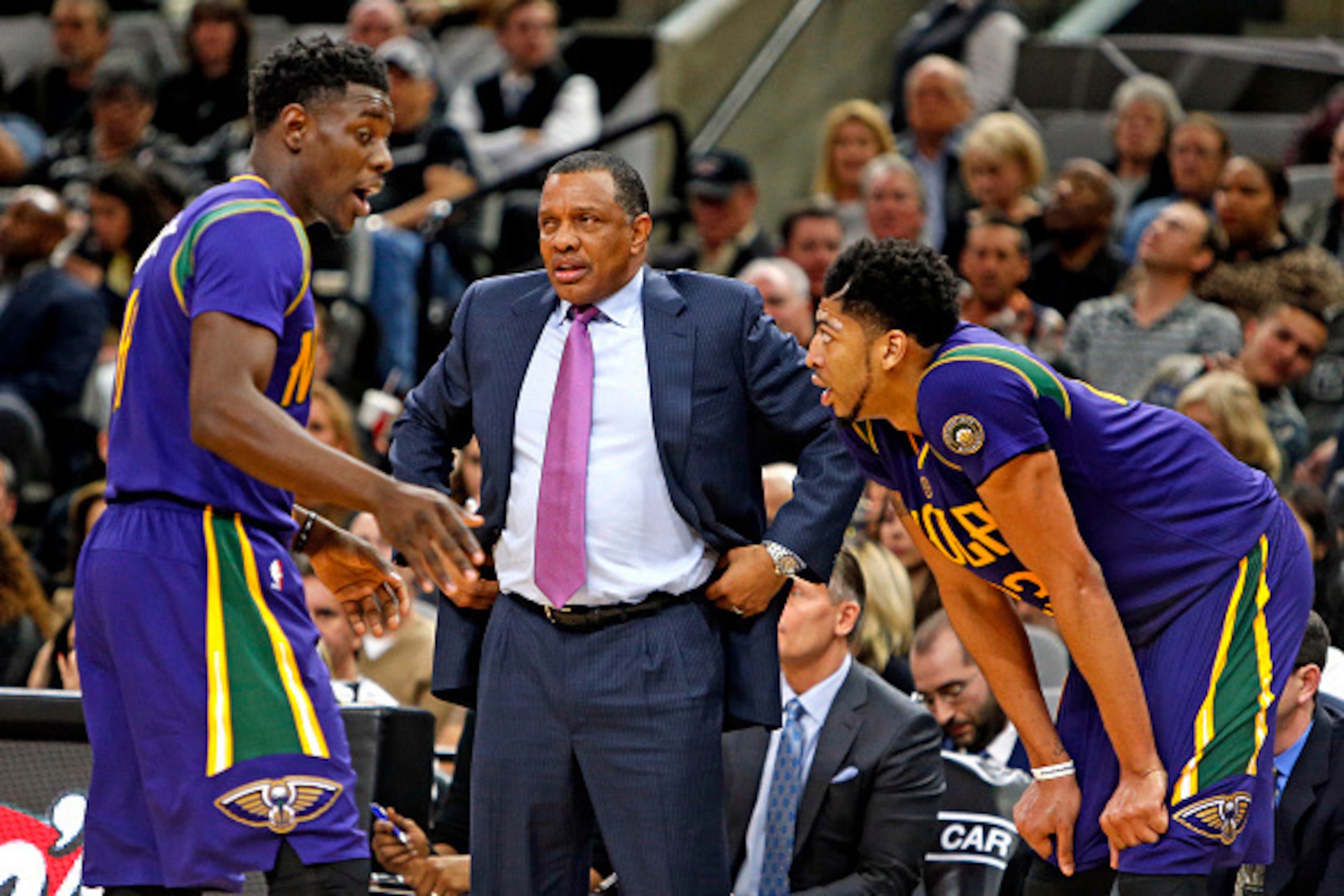 SAN ANTONIO,TX - FEBRUARY 3: Anthony Davis #23 of the New Orleans Pelicans and Jrue Holiday #11 of the New Orleans Pelicans talk while head coach Alvin Gentry surveys the game against  the San Antonio Spurs at AT&T Center on February 3, 2016 in San Antoni