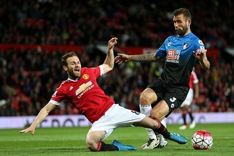 MANCHESTER, ENGLAND - MAY 17:  Juan Mata of Manchester United tangles with Steve Cook of Bournemouth during the Barclays Premier League match between Manchester United and AFC Bournemouth at Old Trafford on May 17, 2016 in Manchester, England.  (Photo by 