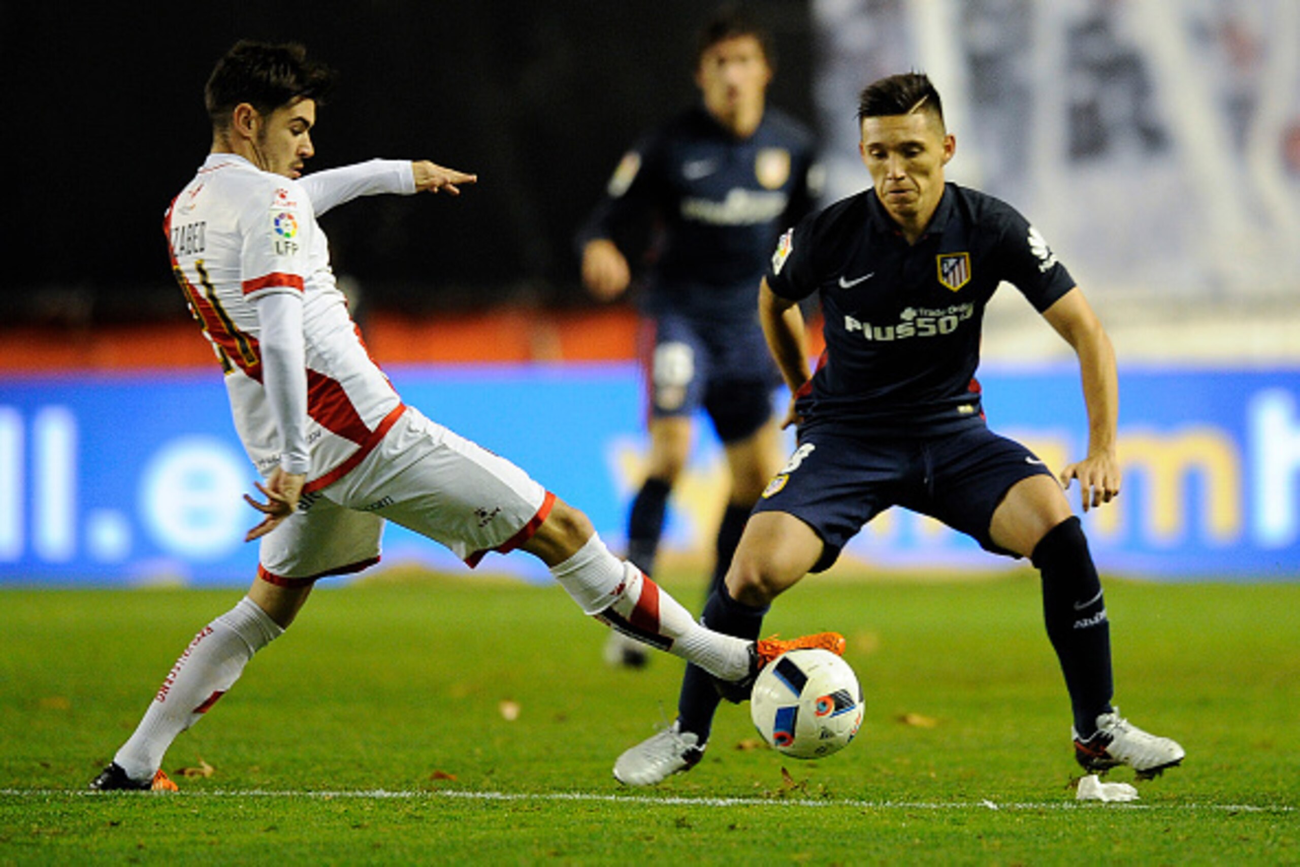 Rayo Vallecano's midfielder Jozabed Sanchez Ruiz (L) vies with Atletico Madrid's Argentinian Matias Kranevitter (L) during the Spanish Copa del Rey (King's Cup) round of 16 first leg football match Club Atletico de Madrid vs CF Rayo Vallecano  at the Vall