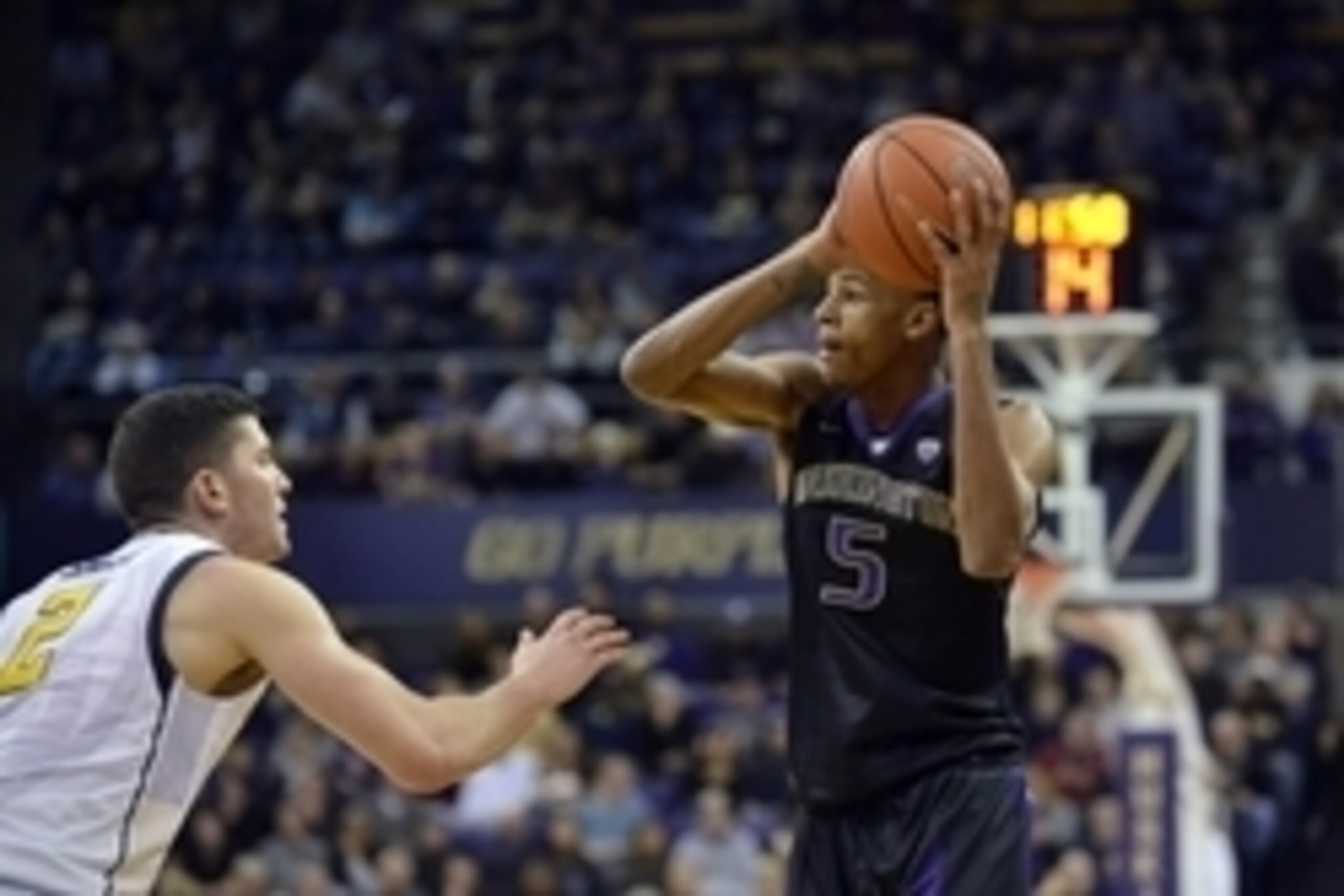 Feb 18, 2016; Seattle, WA, USA; Washington Huskies guard Dejounte Murray (5) looks to pass the ball while being guarded by California Golden Bears guard Sam Singer (2) during the second half at Alaska Airlines Arena. California Golden Bears defeated the W