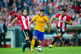BILBAO, SPAIN - AUGUST 14:  Pedro Rodriguez of FC Barcelona (C) duels for the ball with Benat Etxebarria (L) of Athletic Club during the Super Cup first leg match between of Athletic Club and FC Barcelona at San Mames Stadium on August 14, 2015 in Bilbao,