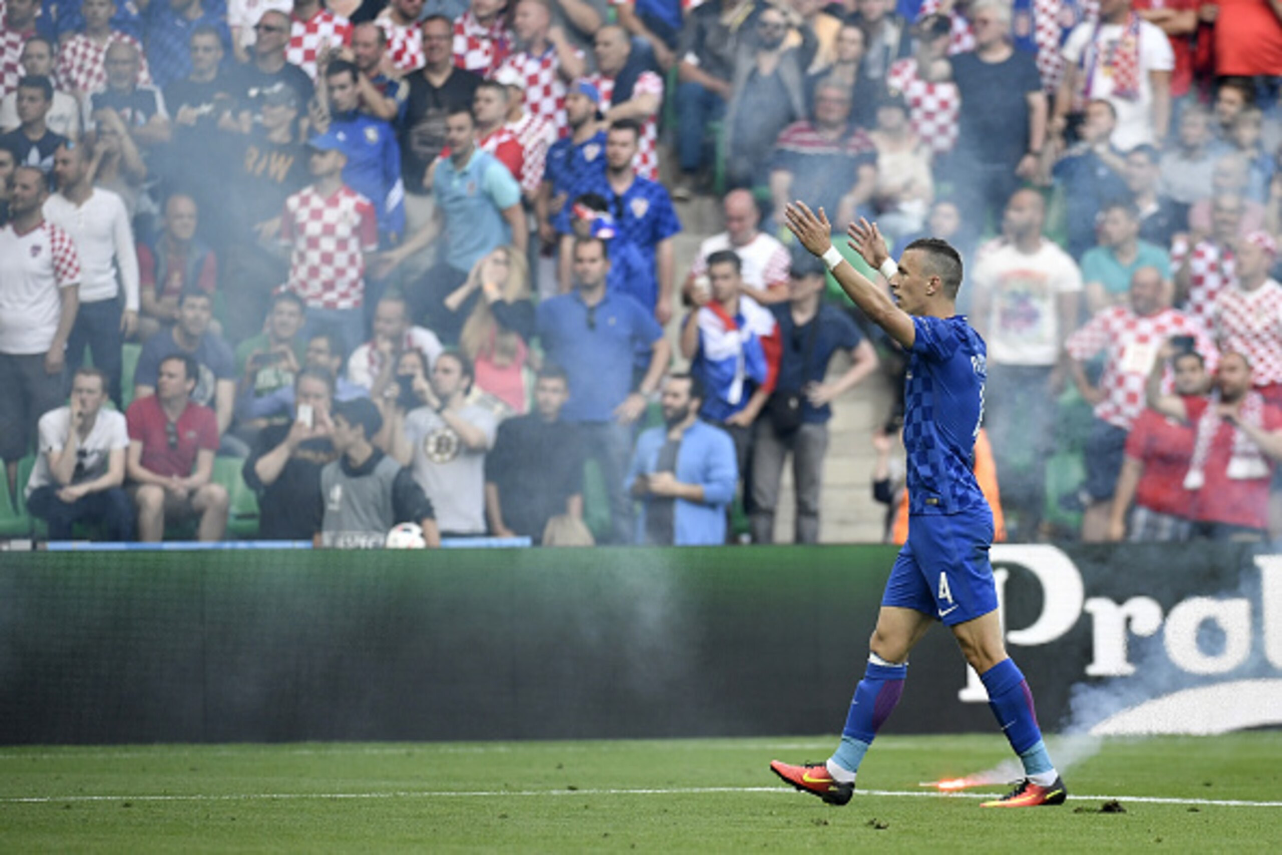 Croatia's midfielder Ivan Perisic reacts after flares were thrown during the Euro 2016 group D football match between Czech Republic and  Croatia at the Geoffroy-Guichard stadium in Saint-Etienne on June 17, 2016. / AFP / jeff pachoud        (Photo credit