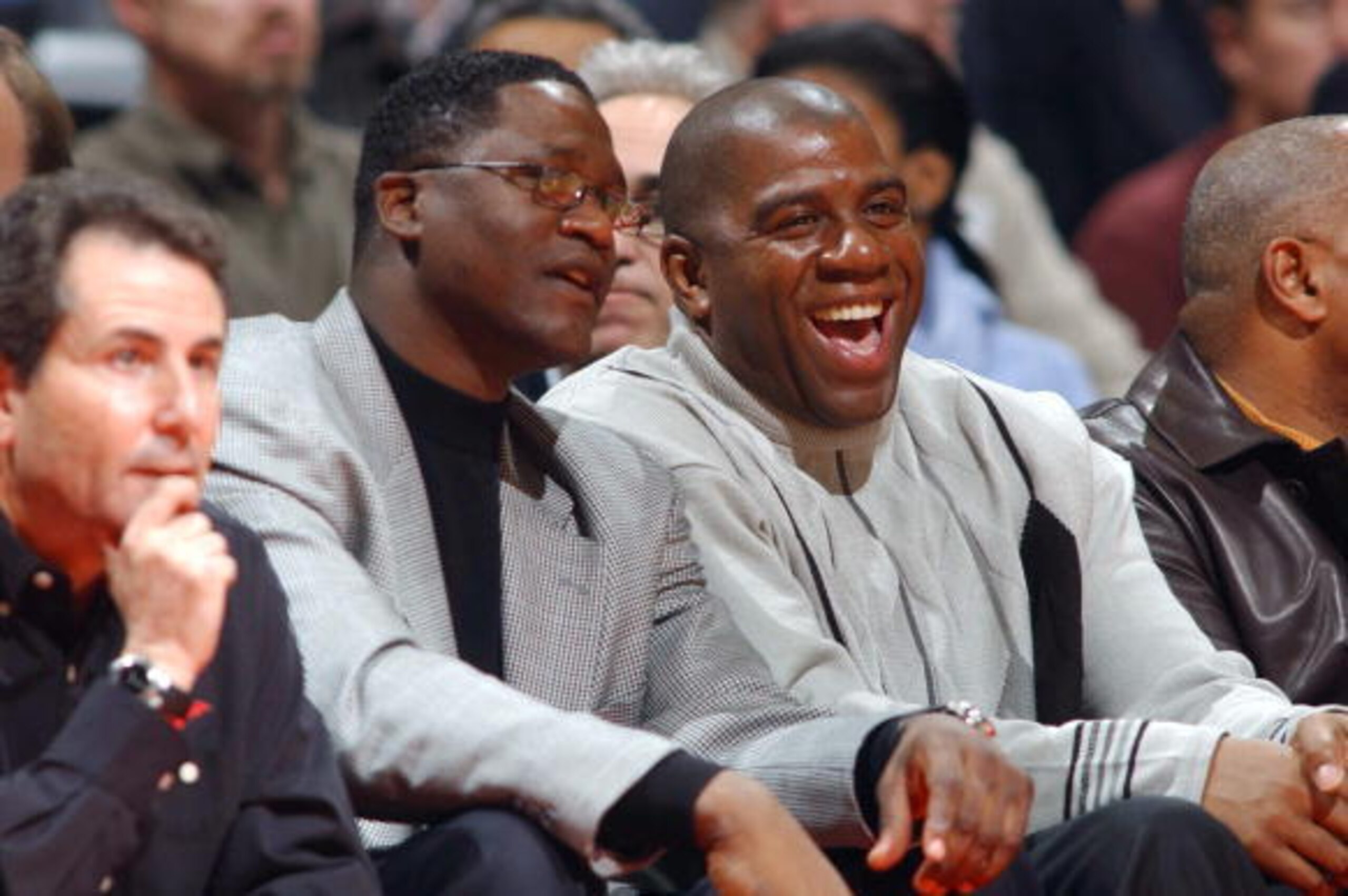 ATLANTA - DECEMBER 9:  NBA legends Dominique Wilkins and Magic Johnson enjoy the game between the Denver Nuggets and the Atlanta Hawks from courtside during a game on December 9, 2003 at Philips Arena in Atlanta, Georgia.  NOTE TO USER: User expressly ack