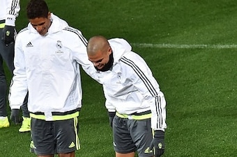 Real Madrid defenders Raphael Varane (L) and Pepe (R) share a smile as Cristiano Ronaldo (C) gestures on the ground after falling during a training session ahead of the International Champions Cup football tournament in Melbourne on July 14, 2015.   AFP P