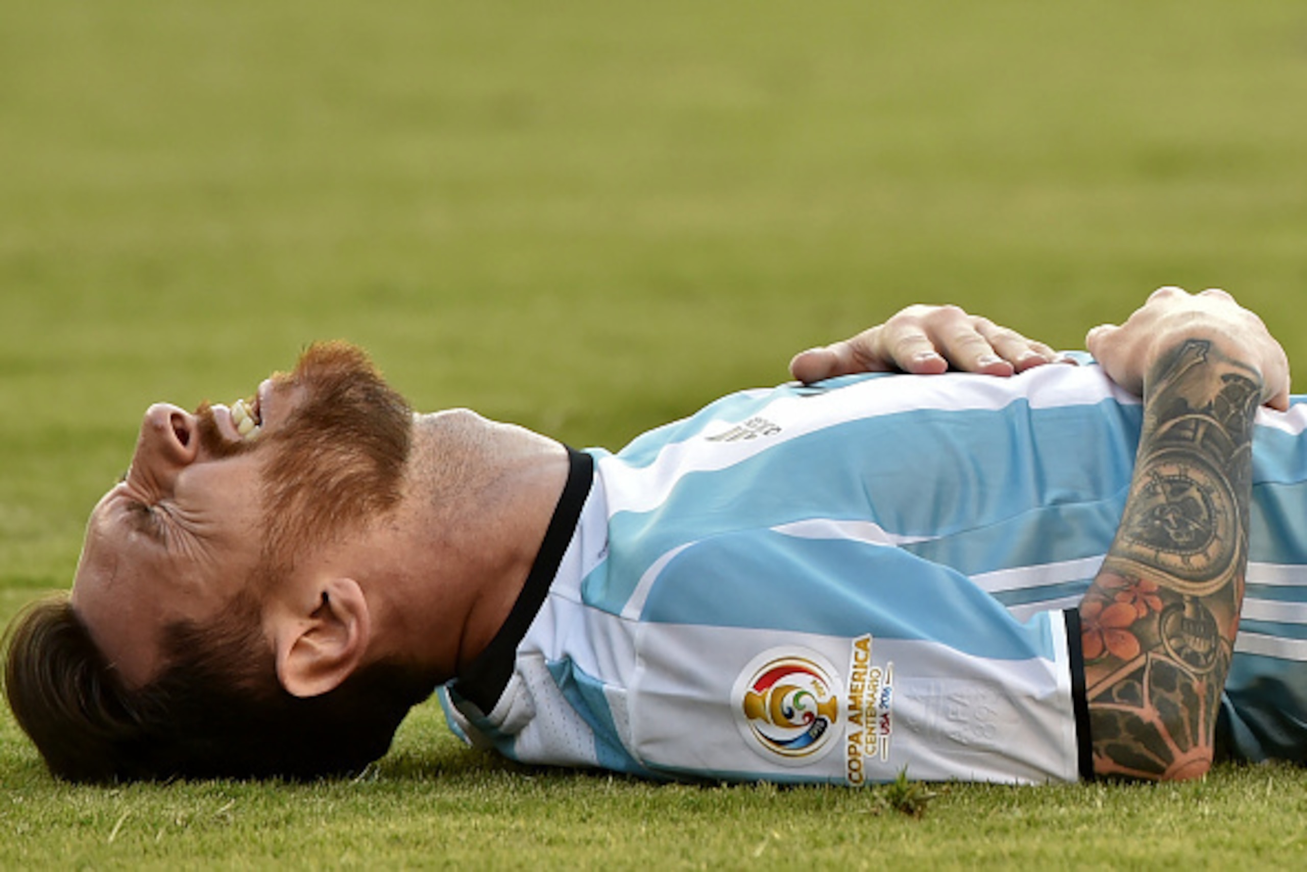 Argentina's Lionel Messi lies on the field during a Copa America Centenario quarterfinal football match against Venezuela in Foxborough, Massachusetts, United States, on June 18, 2016.  / AFP / Nelson ALMEIDA        (Photo credit should read NELSON ALMEID