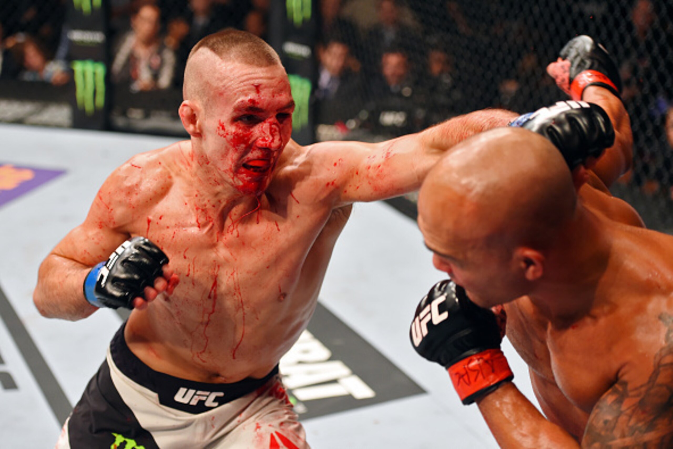 LAS VEGAS, NV - JULY 11:  (L-R) Rory MacDonald punches Robbie Lawler in their UFC welterweight title fight during the UFC 189 event inside MGM Grand Garden Arena on July 11, 2015 in Las Vegas, Nevada.  (Photo by Josh Hedges/Zuffa LLC/Zuffa LLC via Getty I