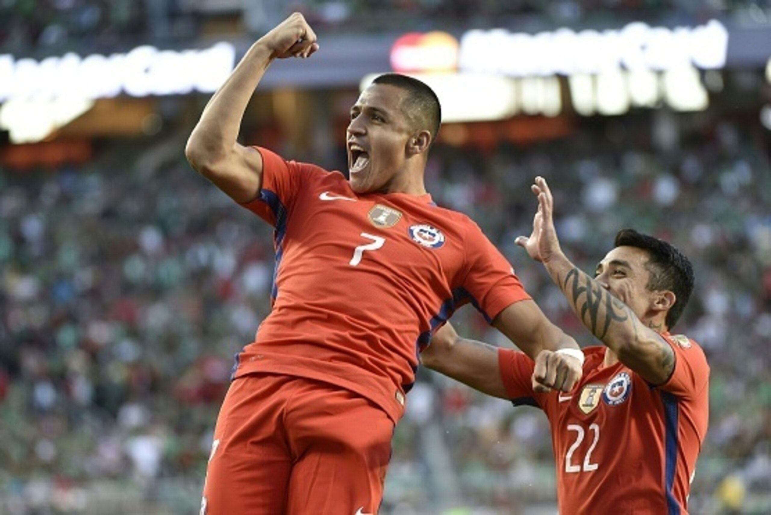 Chile's Alexis Sanchez celebartes a goal against Mexico with teammate Edson Puch  during the Copa America Centenario quarterfinal football match in Santa Clara, California, United States, on June 18, 2016.  / AFP / OMAR TORRES        (Photo credit should 