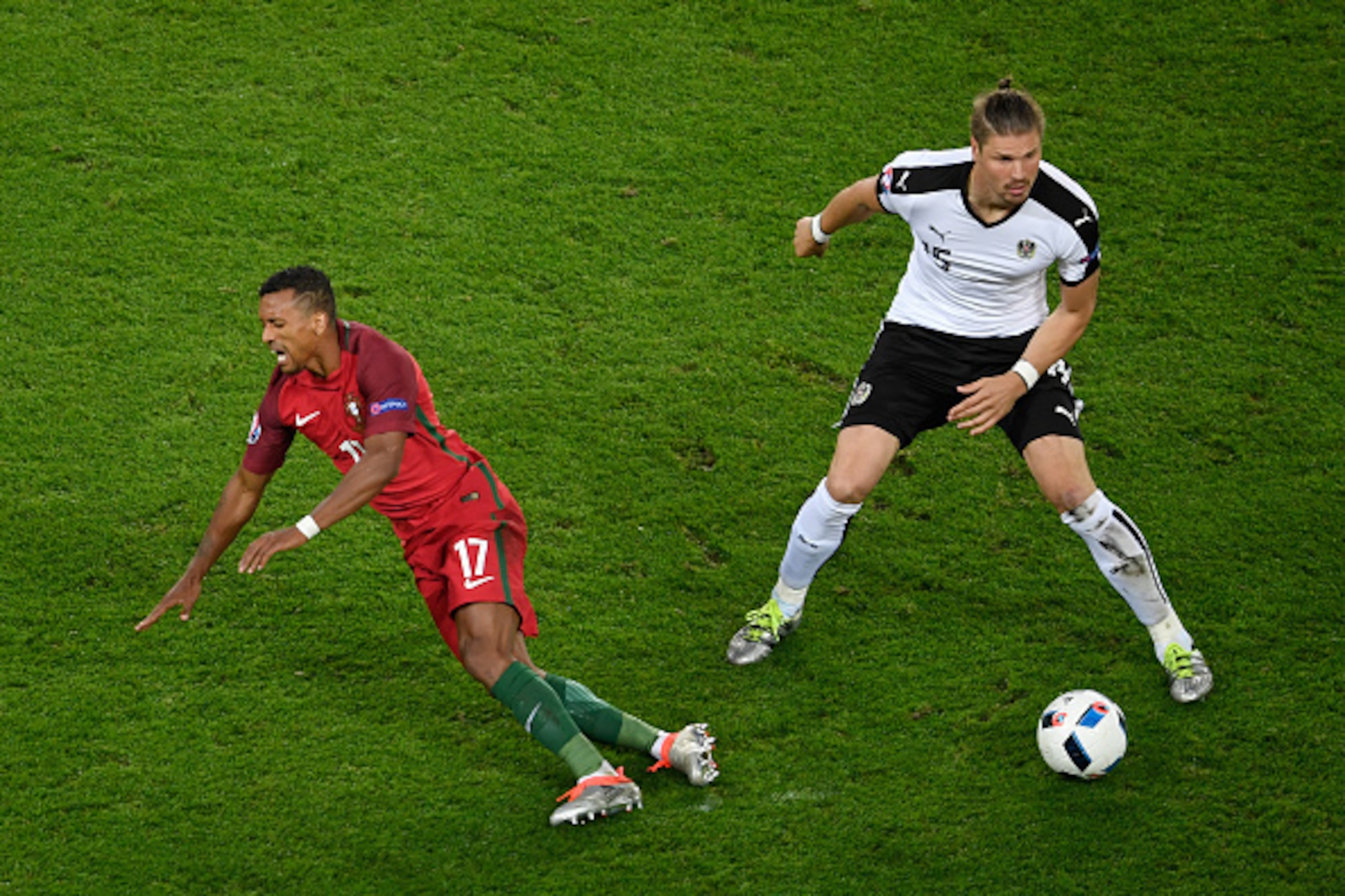 PARIS, FRANCE - JUNE 18: Nani of Portugal goes down after a tackle from Sebastian Proedl of Austria   during the UEFA EURO 2016 Group F match between Portugal and Austria at Parc des Princes on June 18, 2016 in Paris, France.  (Photo by Mike Hewitt/Getty 