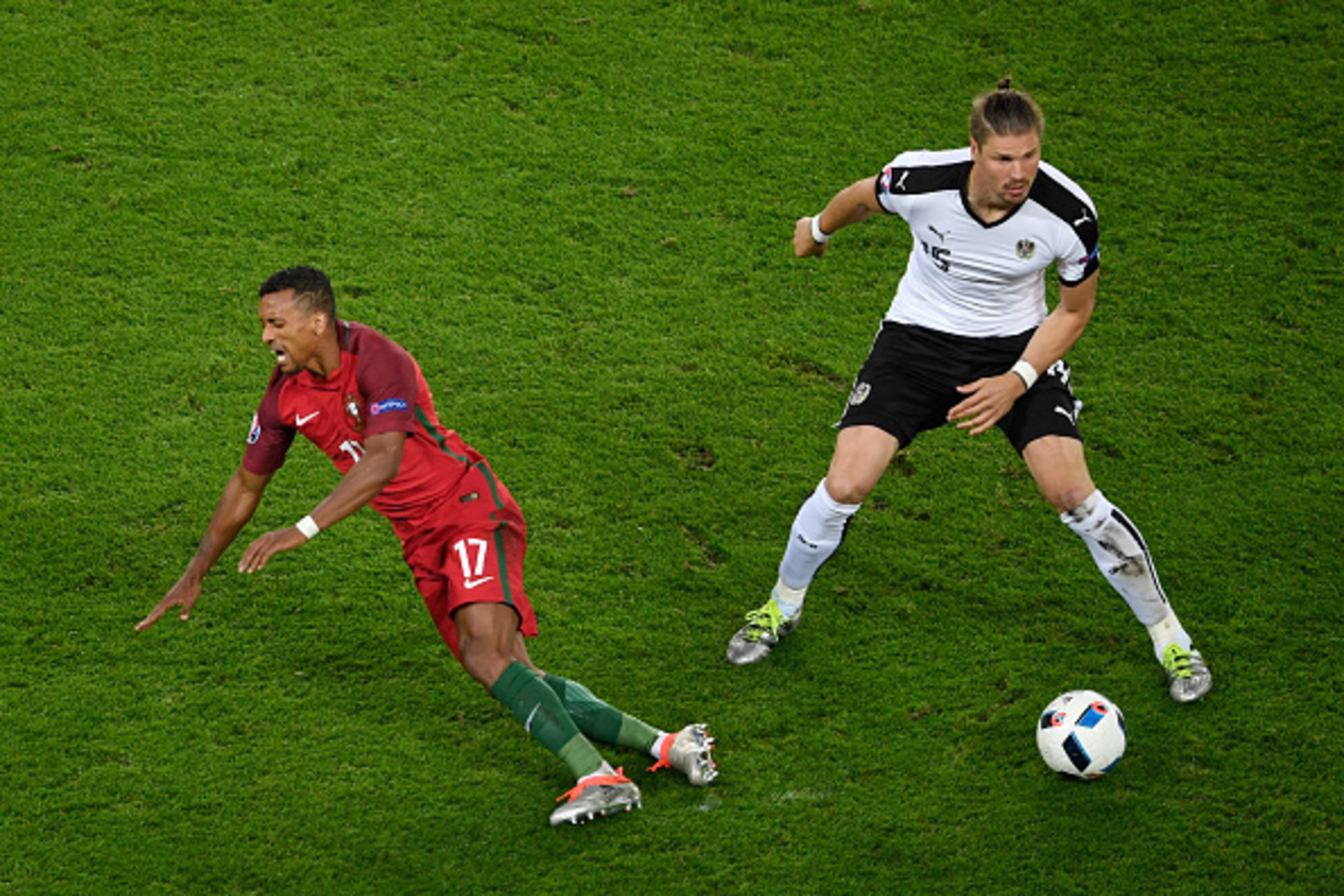 PARIS, FRANCE - JUNE 18: Nani of Portugal goes down after a tackle from Sebastian Proedl of Austria   during the UEFA EURO 2016 Group F match between Portugal and Austria at Parc des Princes on June 18, 2016 in Paris, France.  (Photo by Mike Hewitt/Getty 