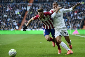 Real Madrid's Brazilian defender Danilo (R) vies with Atletico Madrid's midfielder Saul Niguez during the Spanish league football match Real Madrid CF vs Club Atletico de Madrid at the Santiago Bernabeu stadium in Madrid on February 27, 2016. / AFP / PIER
