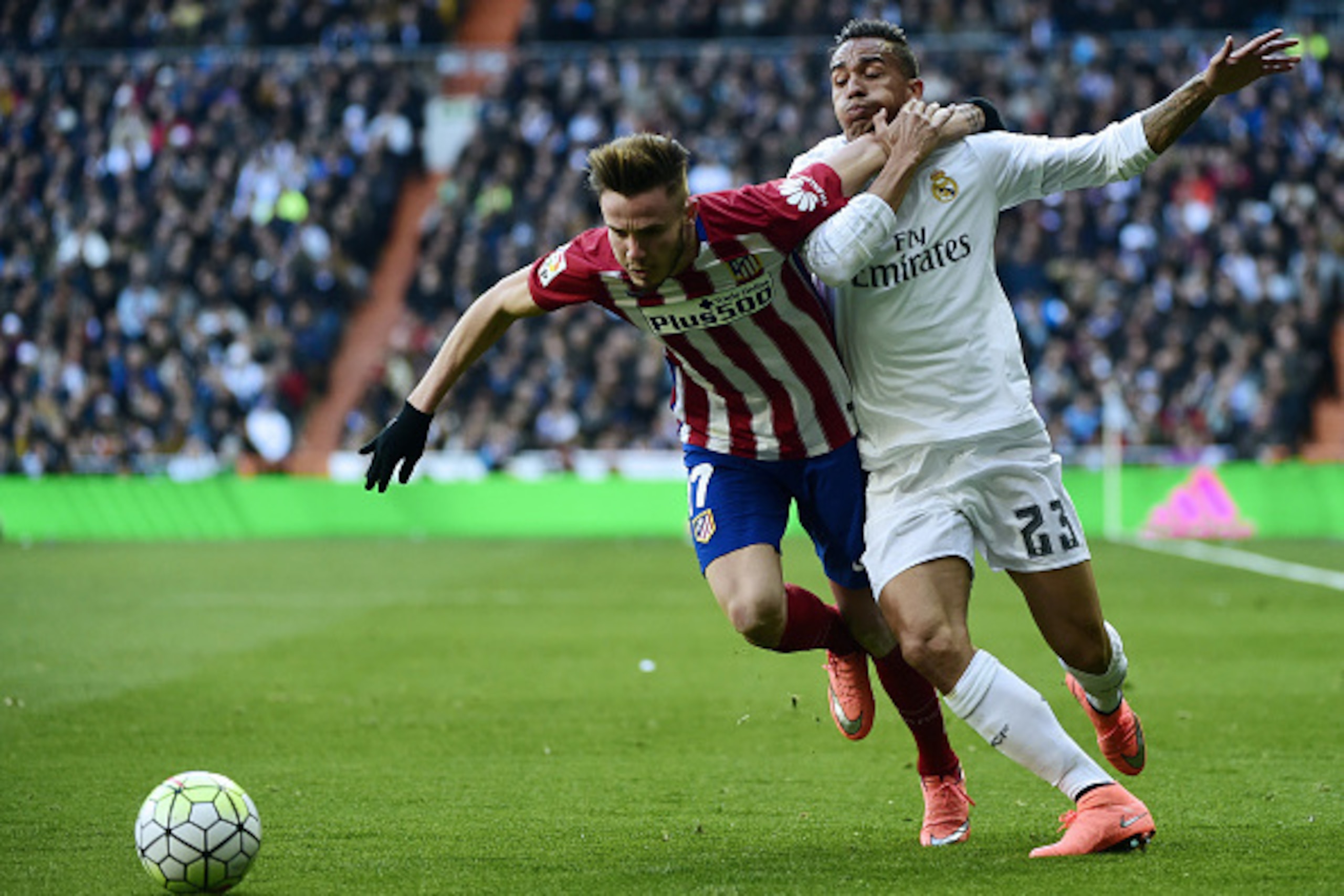 Real Madrid's Brazilian defender Danilo (R) vies with Atletico Madrid's midfielder Saul Niguez during the Spanish league football match Real Madrid CF vs Club Atletico de Madrid at the Santiago Bernabeu stadium in Madrid on February 27, 2016. / AFP / PIER Real Madrid's Brazilian defender Danilo (R) vies with Atletico Madrid's midfielder Saul Niguez during the Spanish league football match Real Madrid CF vs Club Atletico de Madrid at the Santiago Bernabeu stadium in Madrid on February 27, 2016. / AFP / PIER