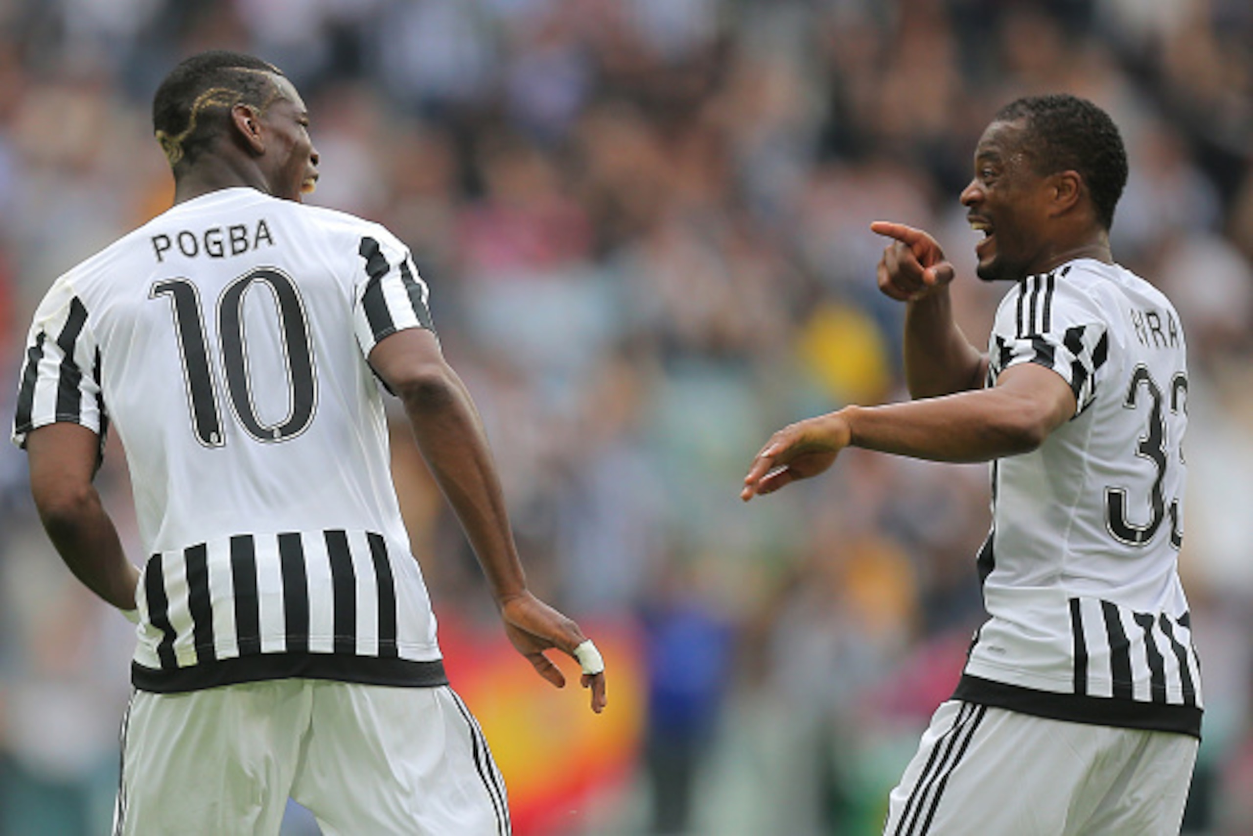 Juventus' midfielder Paul Pogba from France (L) celebrates after scoring with Juventus' defender Patrice Evra from France during the Italian Serie A football match Juventus vs Palermo on April 17, 2016 at the Juventus stadium in Turin.  / AFP / MARCO BERT