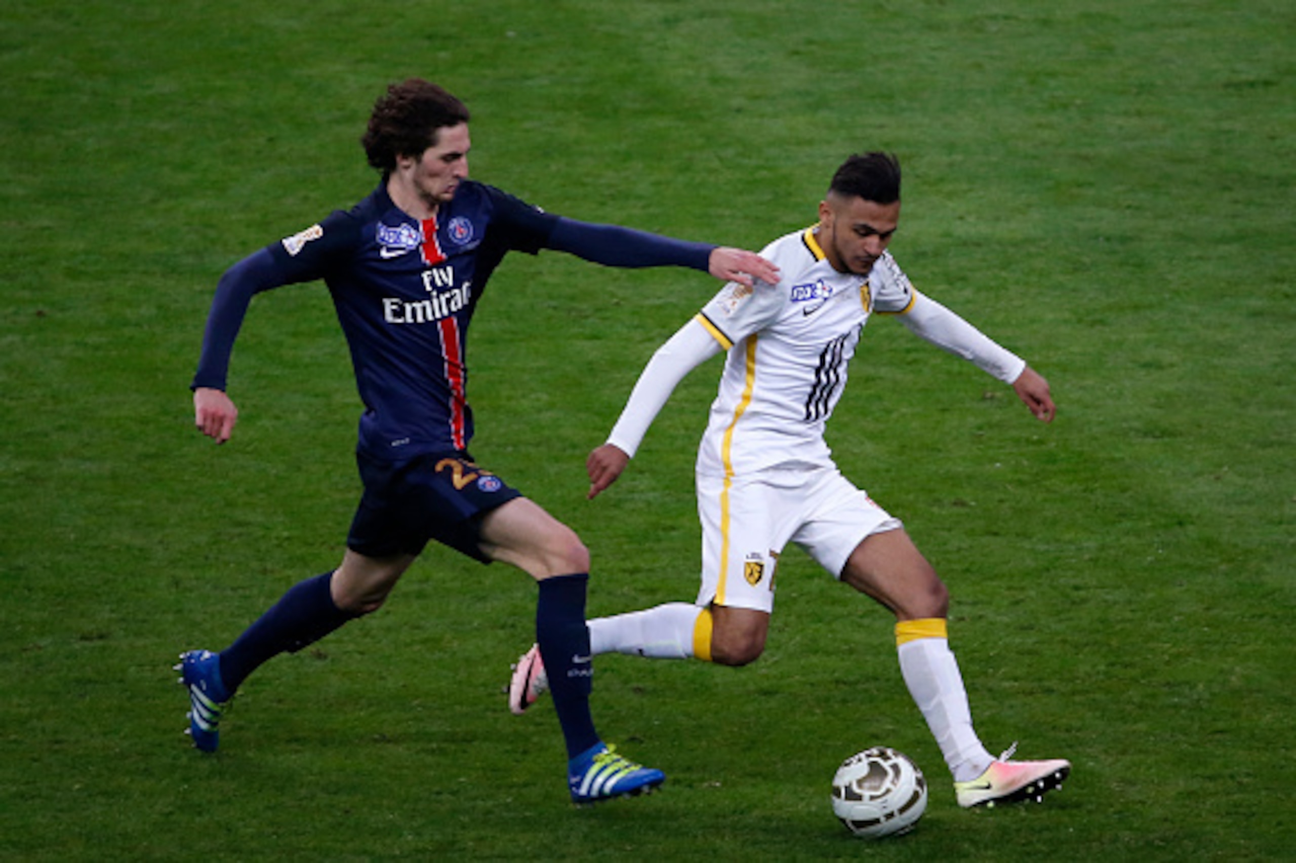Paris Saint-Germain's French midfielder Adrien Rabiot (L) vies with Lille's French midfielder Sofiane Boufal during the French League Cup final football match between Paris Saint-Germain and Lille on April 23, 2016 at the Stade de France in Saint-Denis, n