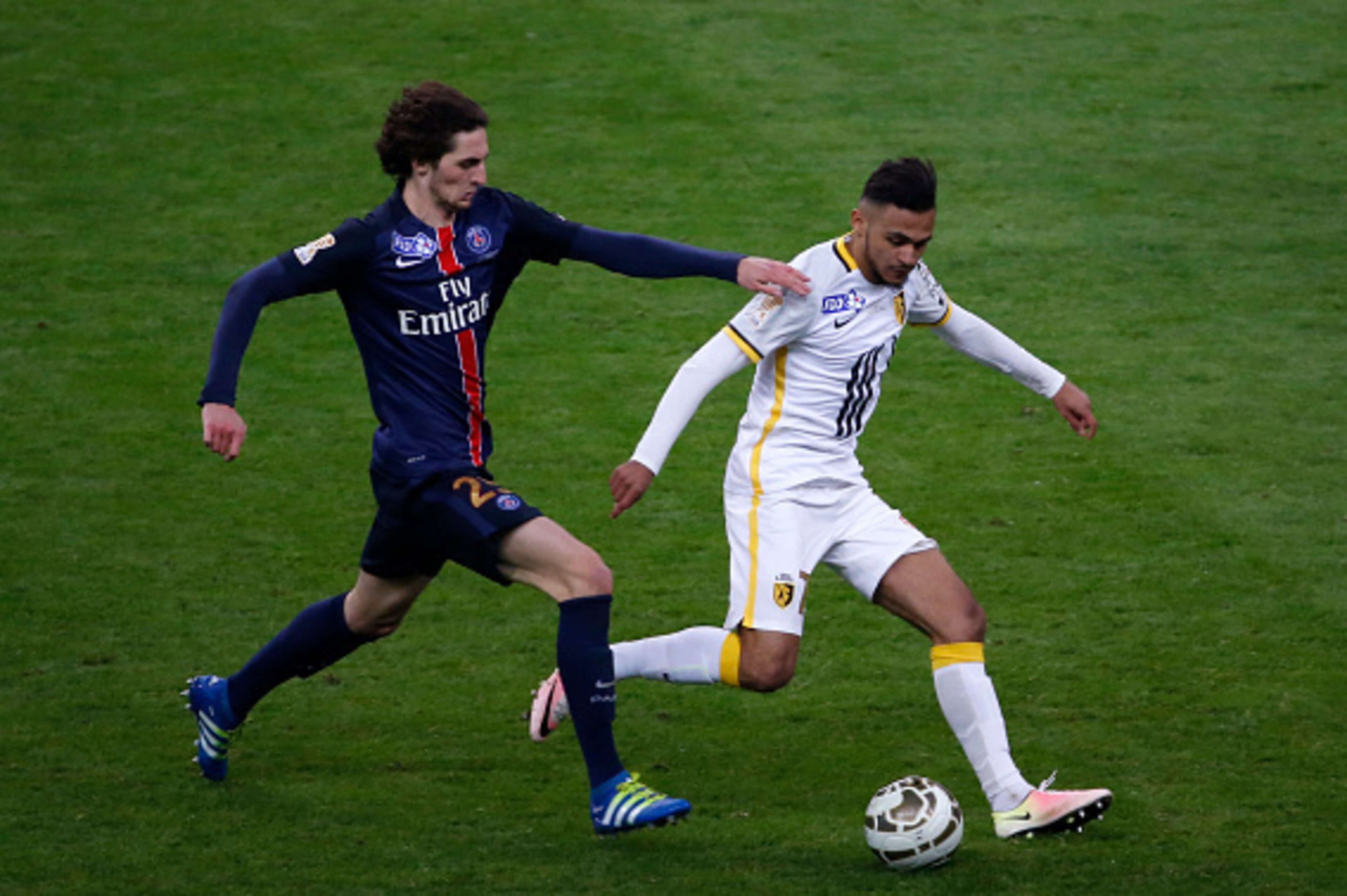 Paris Saint-Germain's French midfielder Adrien Rabiot (L) vies with Lille's French midfielder Sofiane Boufal during the French League Cup final football match between Paris Saint-Germain and Lille on April 23, 2016 at the Stade de France in Saint-Denis, n