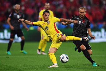 LYON, FRANCE - JUNE 19:  Romania's Nicolae Stanciu under pressure from Albania's Migjen Basha during the UEFA Euro 2016 Group A match between Romania and Albania at Stade de Lyon on June 19 in Lyon, France.  (Photo by Kevin Barnes/CameraSport via Getty Im