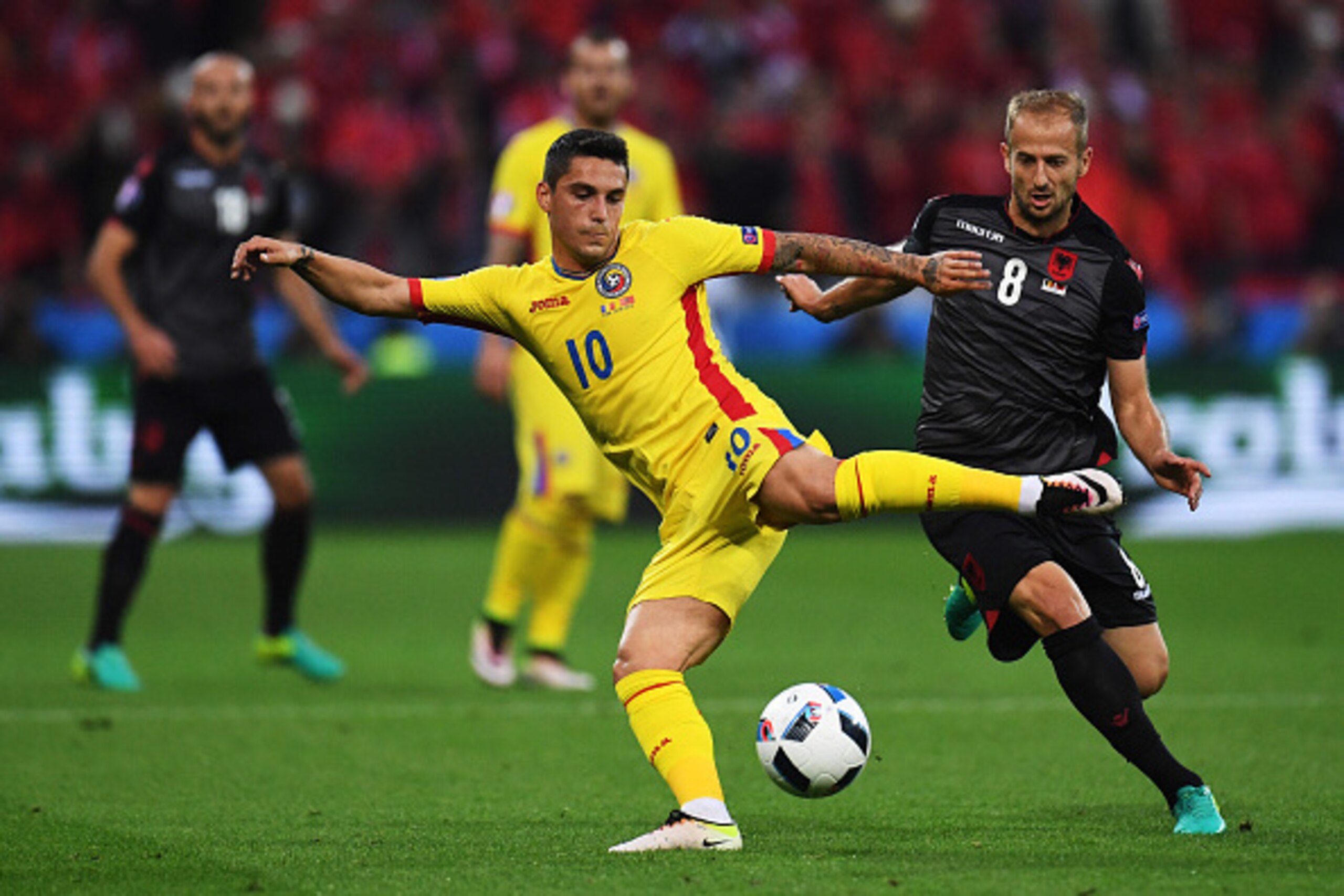 LYON, FRANCE - JUNE 19:  Romania's Nicolae Stanciu under pressure from Albania's Migjen Basha during the UEFA Euro 2016 Group A match between Romania and Albania at Stade de Lyon on June 19 in Lyon, France.  (Photo by Kevin Barnes/CameraSport via Getty Im