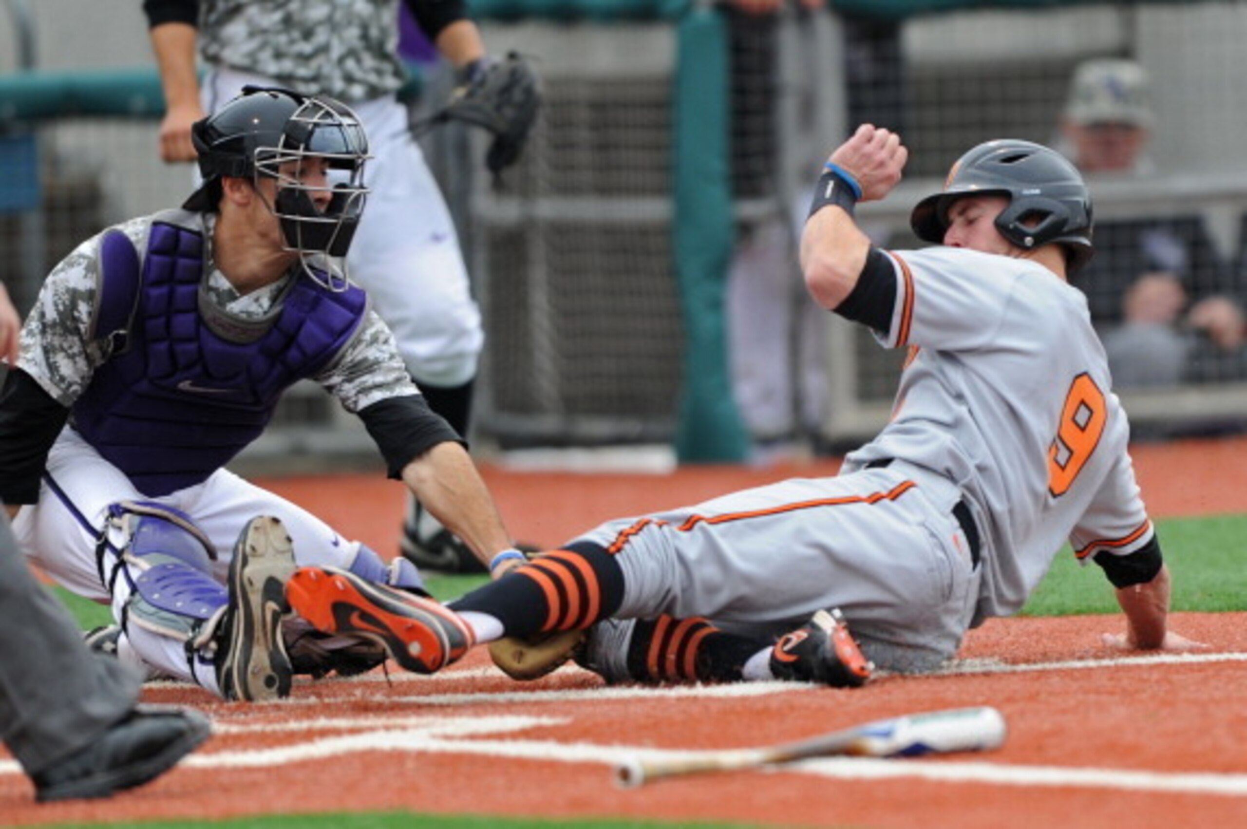 MANHATTAN, KS - APRIL 29:  Base runner Mark Ginther #9 of the Oklahoma State Cowboys is tagged out at home plate by catcher Dan Klein (L) of the Kansas State Wildcats during the sixth inning on April 29, 2012 at Tointon Stadium in Manhattan, Kansas.  (Pho
