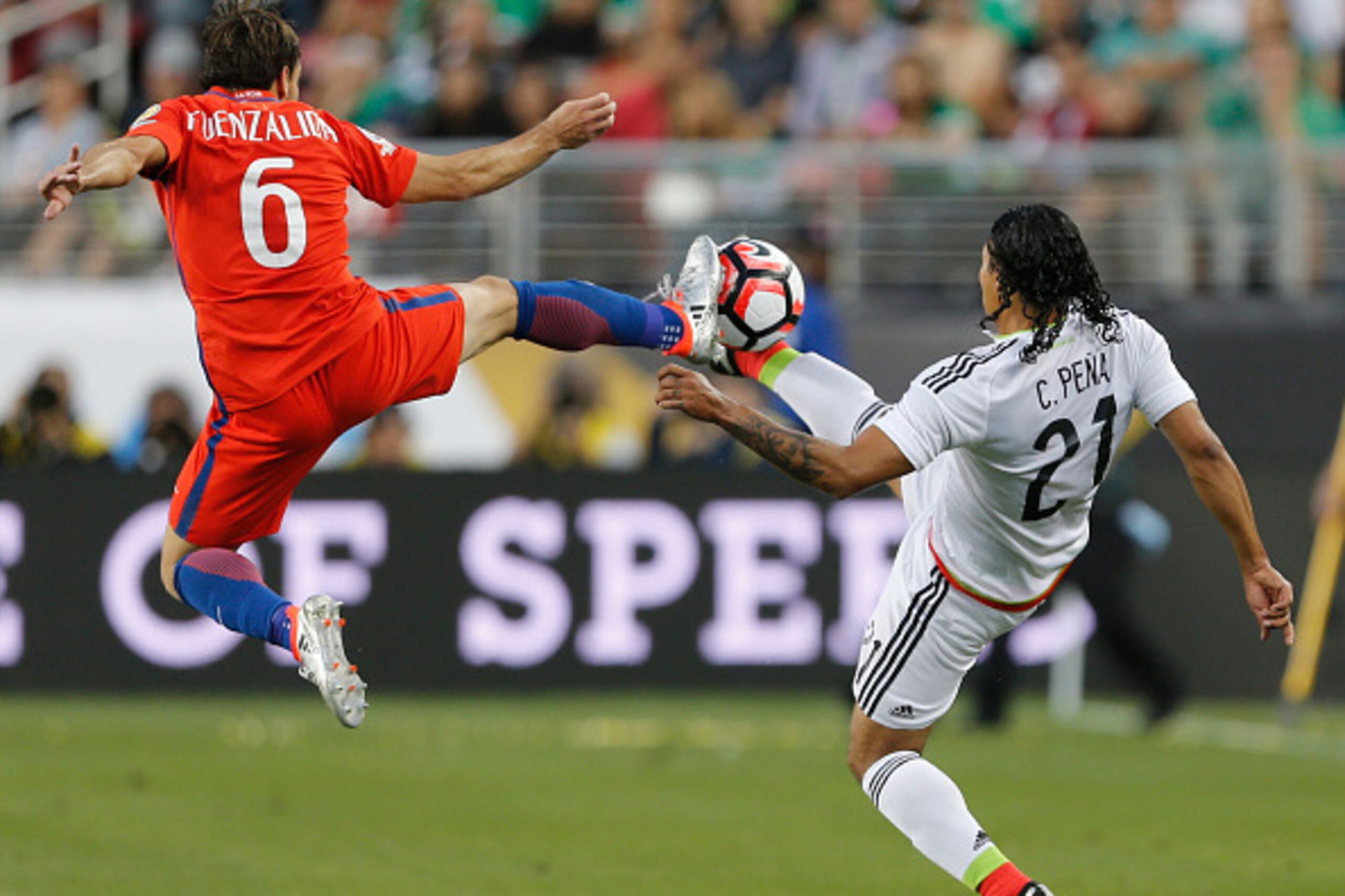 Mexico's Carlos Pena (R) vies for the ball with Chile's Jose Fuenzalida during a Copa  America Centenario quarterfinal football match in Santa Clara, California, United States, on June 18, 2016. 
Chile defeated Mexico by 7-0 and qualified for semi-finals.