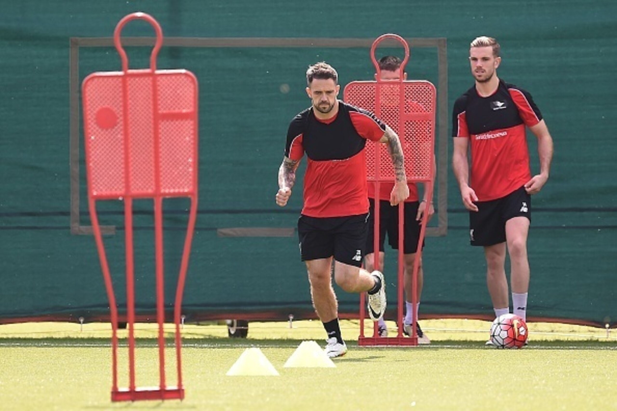 Liverpool's English striker Danny Ings (L), Liverpool's English midfielder James Milner (C) and Liverpool's English midfielder Jordan Henderson take part in a team training session at their Melwood training complex in Liverpool, north west England, on May