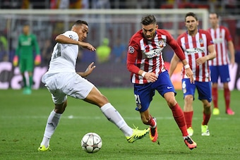 Real Madrid's Brazilian defender Danilo (L) and Atletico Madrid's Belgian forward Yannick Ferreira Carrasco fight for the ball during the UEFA Champions League final football match between Real Madrid and Atletico Madrid at San Siro Stadium in Milan, on M