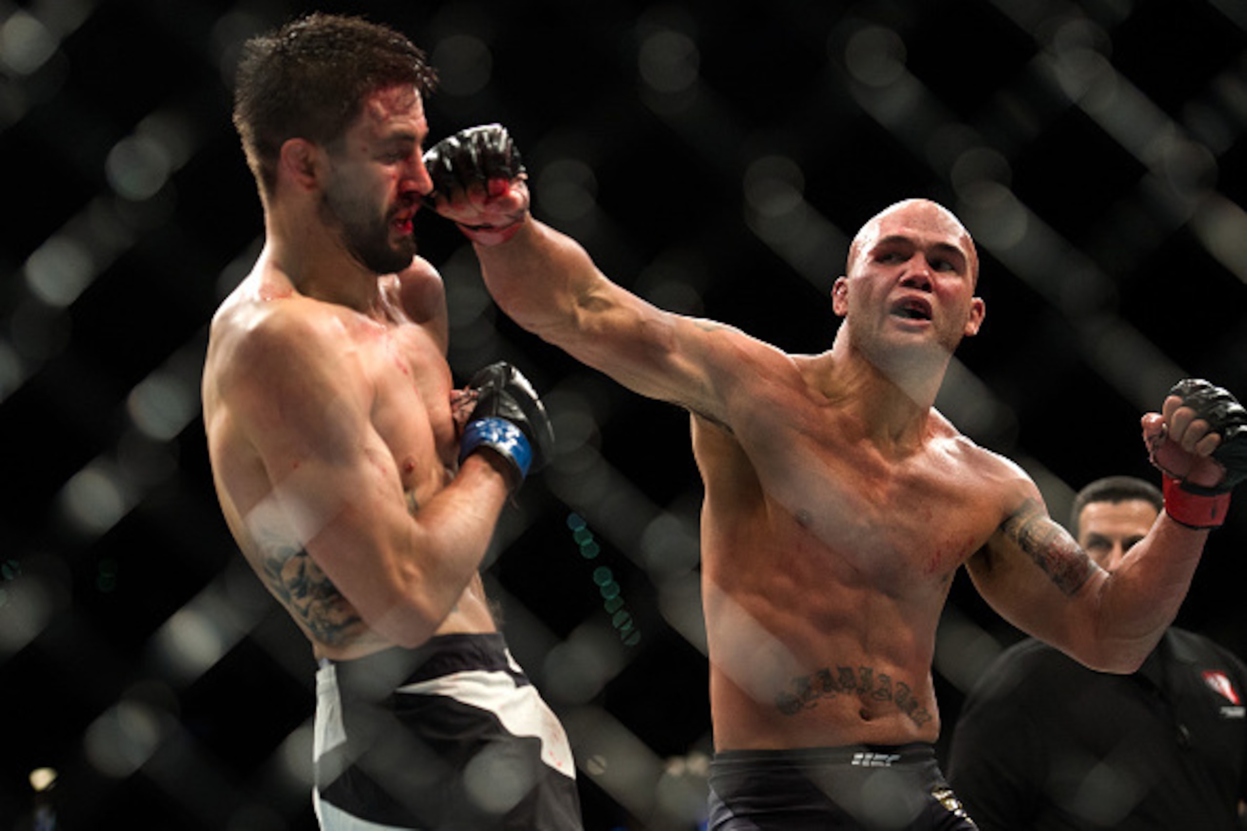 LAS VEGAS, NV - JANUARY 02:  (R-L) Robbie Lawler punches Carlos Condit in their welterweight championship fight during the UFC 195 event inside MGM Grand Garden Arena on January 2, 2016 in Las Vegas, Nevada.  (Photo by Brandon Magnus/Zuffa LLC/Zuffa LLC v
