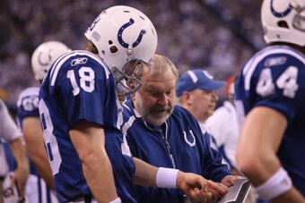 INDIANAPOLIS - DECEMBER 27:  Quarterback Peyton Manning #18 of the Indianapolis Colts goes over a play  with Sr. Offensive Offensive Line Coach Howard Mudd against the New York Jets at Lucas Oil Stadium on December 27, 2009 in Indianapolis, Indiana. The J