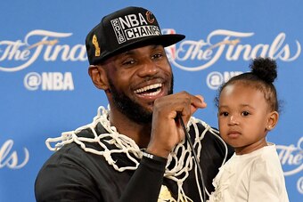 OAKLAND, CA - JUNE 19:  LeBron James #23 of the Cleveland Cavaliers holds his daughter Zhuri during a press conference after defeating the Golden State Warriors 93-89 in Game 7 to win the 2016 NBA Finals at ORACLE Arena on June 19, 2016 in Oakland, Califo