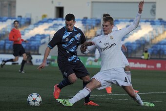 MADRID, SPAIN - FEBRUARY 17:  Philipp Lienhart of Real Madrid tackles Ruben Macedo of FC Porto during the UEFA Youth League Round of 16 match between Real Madrid and FC Porto at Estadio Alfredo Di Stefano on February 17, 2015 in Madrid, Spain.  (Photo by 