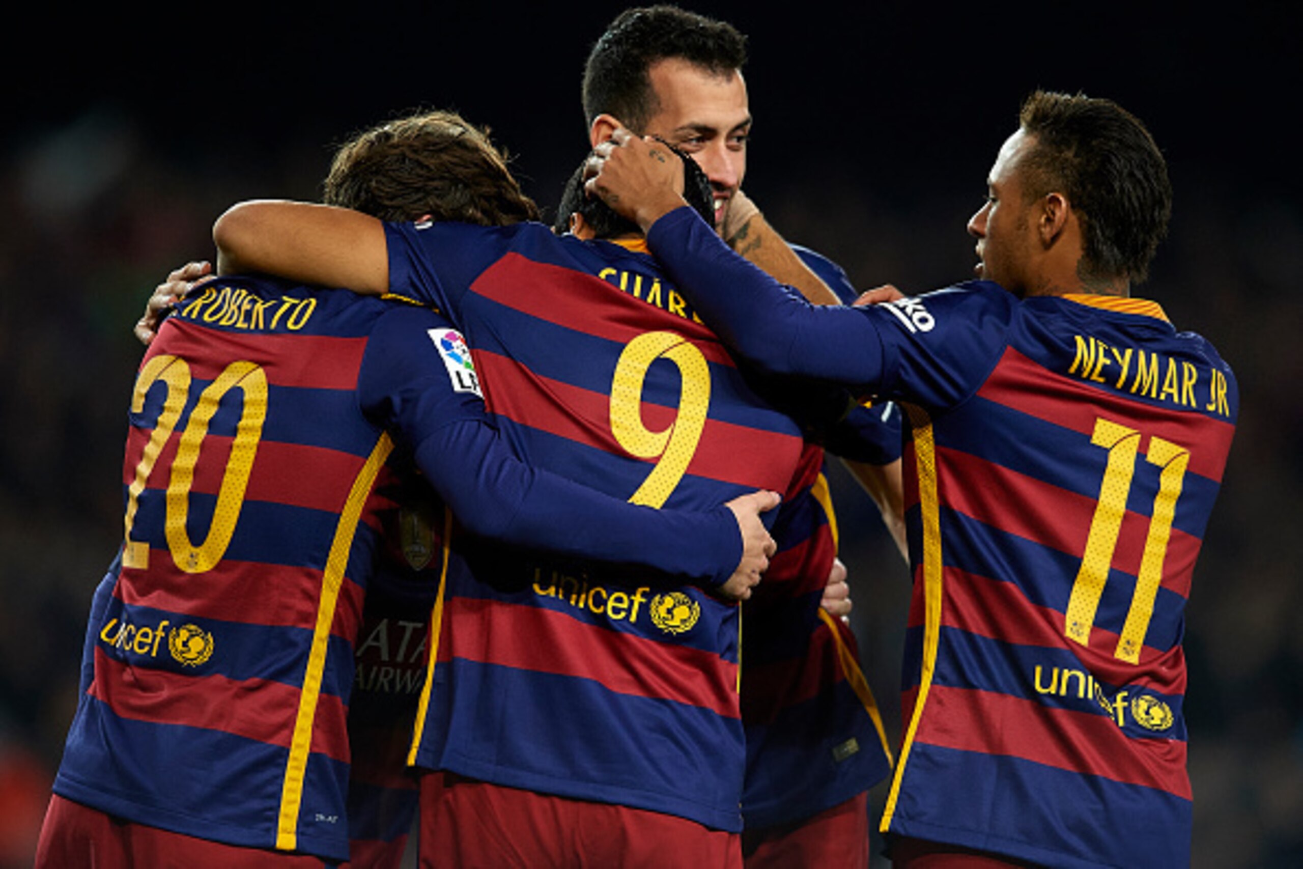 BARCELONA, SPAIN - DECEMBER 30:  Luis Suarez (9) of FC Barcelona celebrates with his teammates Neymar, Sergi Roberto and Sergio Busquets after scoring his team's third goal during during the La Liga match between FC Barcelona and Real Betis Balompie at Ca