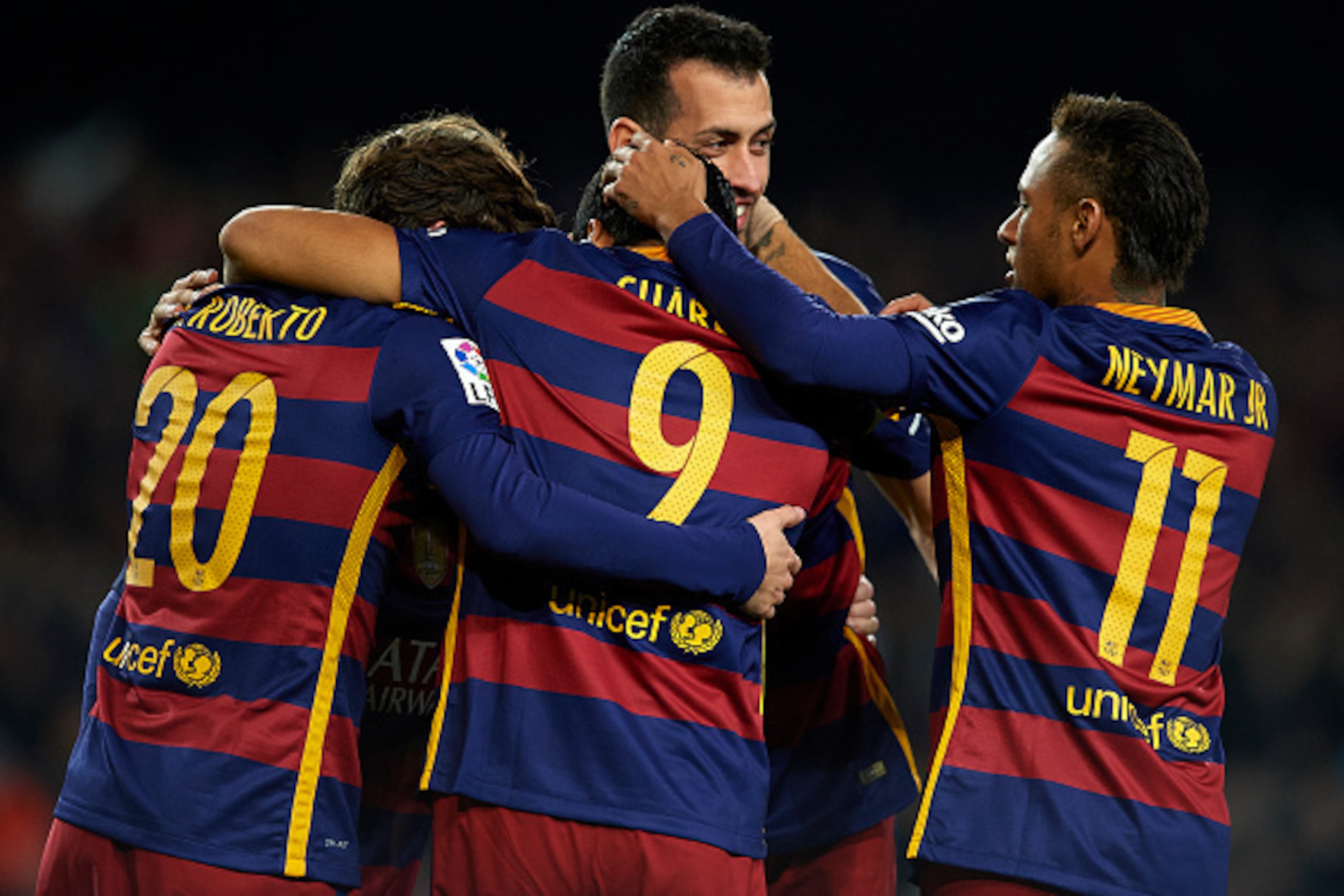 BARCELONA, SPAIN - DECEMBER 30:  Luis Suarez (9) of FC Barcelona celebrates with his teammates Neymar, Sergi Roberto and Sergio Busquets after scoring his team's third goal during during the La Liga match between FC Barcelona and Real Betis Balompie at Ca