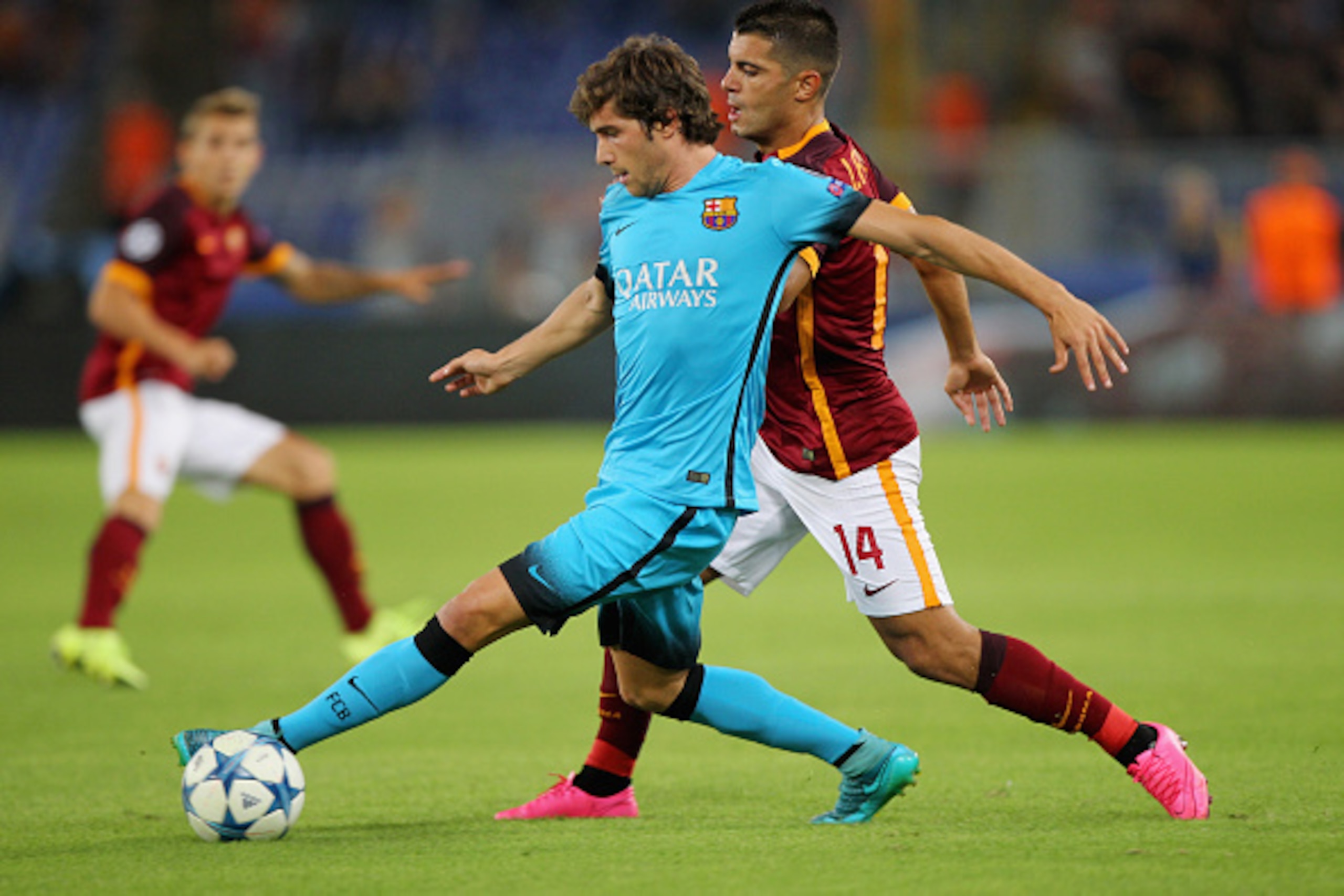 ROME, ITALY - SEPTEMBER 16:  Iago Falque (R) of AS Roma competes for the ball with Sergi Roberto of FC Barcelona during the UEFA Champions League Group E match between AS Roma and FC Barcelona at Stadio Olimpico on September 16, 2015 in Rome, Italy.  (Pho