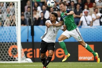Northern Ireland's defender Jonny Evans (R) and Germany's midfielder Sami Khedira vie for the ball during the Euro 2016 group C football match between Northern Ireland and Germany at the Parc des Princes stadium in Paris on June 21, 2016. / AFP / ODD ANDE