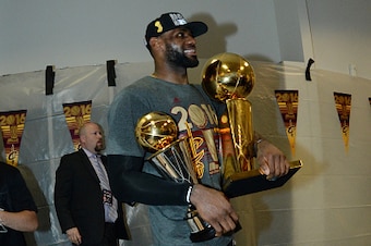OAKLAND, CA - JUNE 19:  LeBron James #23 of the Cleveland Cavaliers celebrates with the Larry O'Brien NBA Championship Trophy and the Bill Russell NBA Finals Most Valuable Player Award after winning Game Seven of the 2016 NBA Finals against the Golden Sta