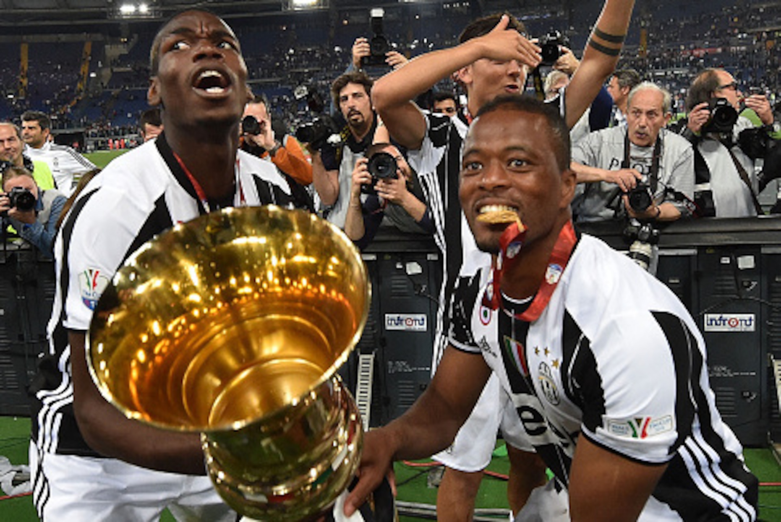 ROME, ITALY - MAY 21:  Paul Pogba, Paulo Dybala and Patrice Evra of Juventus FC celebrate the victory after the TIM Cup match between AC Milan and Juventus FC at Stadio Olimpico on May 21, 2016 in Rome, Italy.  (Photo by Giuseppe Bellini/Getty Images)