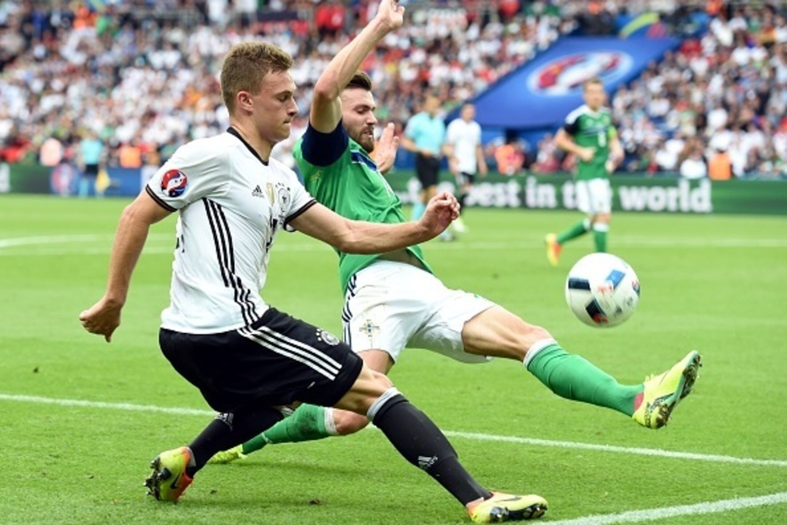 (LtoR) Germany's midfielder Joshua Kimmich and Northern Ireland's forward Kyle Lafferty vie for the ball during the Euro 2016 group C football match between Northern Ireland and Germany at the Parc des Princes stadium in Paris on June 21, 2016. / AFP / PA