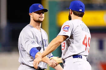 PITTSBURGH, PA - SEPTEMBER 15: Jon Lester #34 is congratulated by teammate Jake Arrieta #49 of the Chicago Cubs following his complete game win against the Pittsburgh Pirates during game two of the doubleheader at PNC Park on September 15, 2015 in Pittsbu
