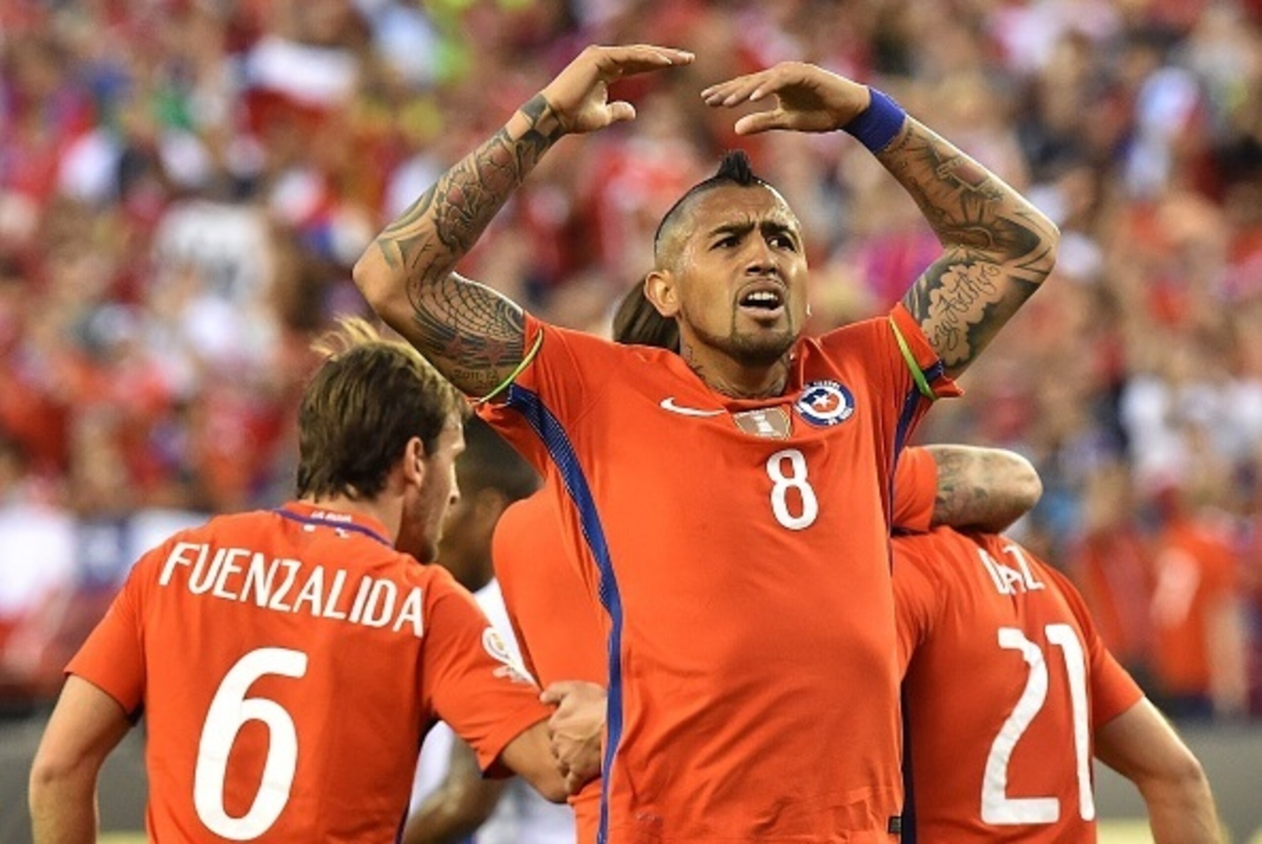 Chile's Arturo Vidal celebrates after teammate Eduardo Vargas scored against Panama during their Copa America Centenario football tournament match in Philadelphia, Pennsylvania, United States, on June 14, 2016.  / AFP / NICHOLAS KAMM        (Photo credit 