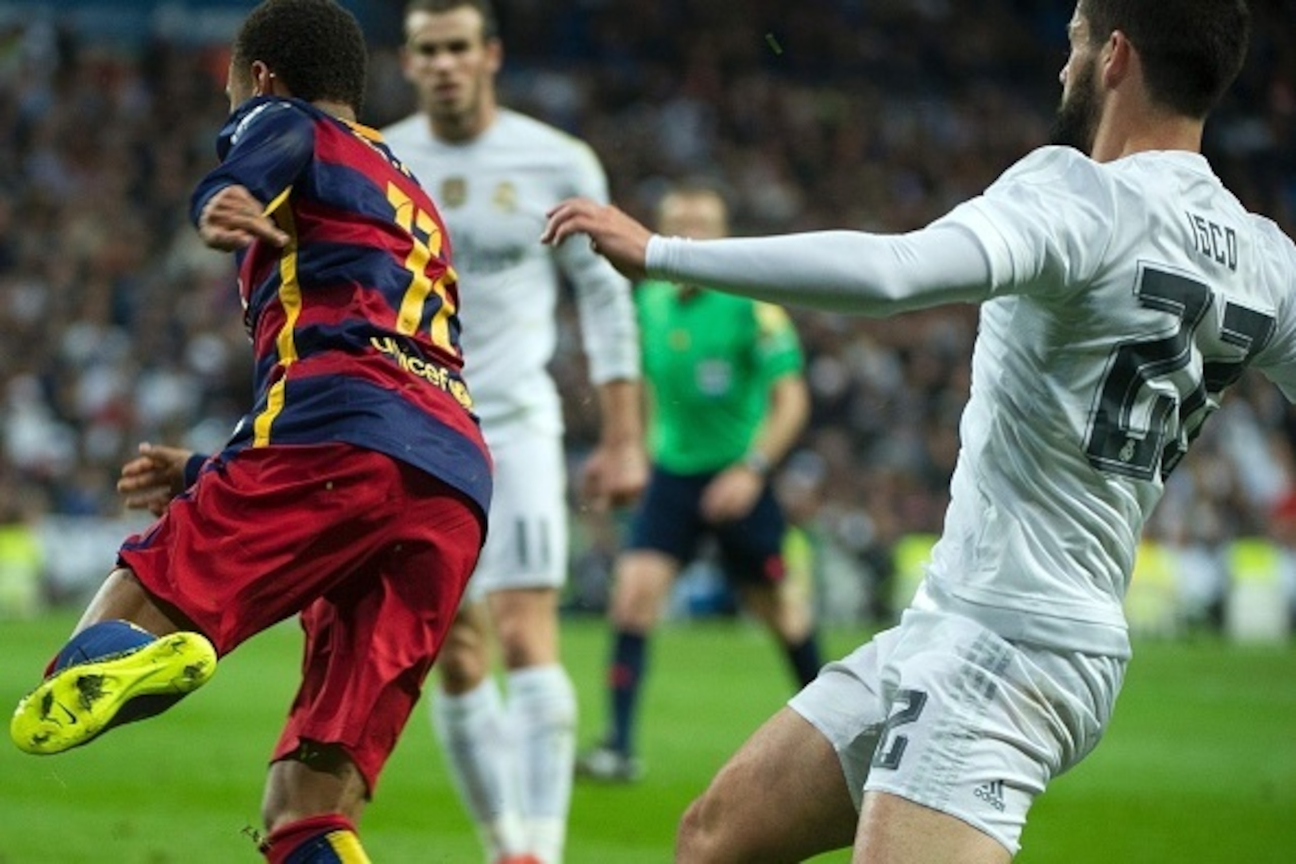 Real Madrid's midfielder Isco (R) tackles Barcelona's Brazilian forward Neymar (L) during the Spanish league 'Clasico' football match Real Madrid CF vs FC Barcelona at the Santiago Bernabeu stadium in Madrid on November 21, 2015. AFP PHOTO / CURTO DE LA T