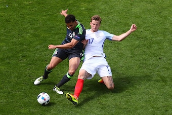 LENS, FRANCE - JUNE 16:  Hal Robson-Kanu of Wales is tackled by Eric Dier of England during the UEFA EURO 2016 Group B match between England and Wales at Stade Bollaert-Delelis on June 16, 2016 in Lens, France.  (Photo by Clive Rose/Getty Images)