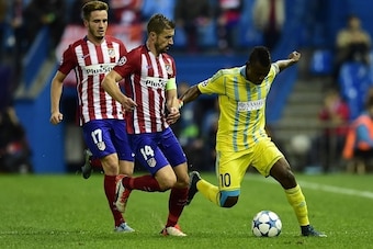 Astana's Central African midfielder Foxi Kethevoama (R) vies with Atletico Madrid's midfielder Gabi (C) and Atletico Madrid's midfielder Saul Niguez during the UEFA Champions League group C football match Club Atletico de Madrid vs FC Astana at the Vicent