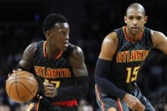 Mar 26, 2016; Auburn Hills, MI, USA; Atlanta Hawks guard Dennis Schroder (17) dribbles the ball past center Al Horford (15) during the fourth quarter against the Detroit Pistons at The Palace of Auburn Hills. Hawks win 112-95. Mandatory Credit: Raj Mehta-