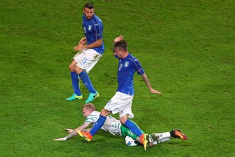 LILLE, FRANCE - JUNE 22:  James McClean of Republic of Ireland is challenged by Federico Bernardeschi of Italy in the penalty area during the UEFA EURO 2016 Group E match between Italy and Republic of Ireland at Stade Pierre-Mauroy on June 22, 2016 in Lil