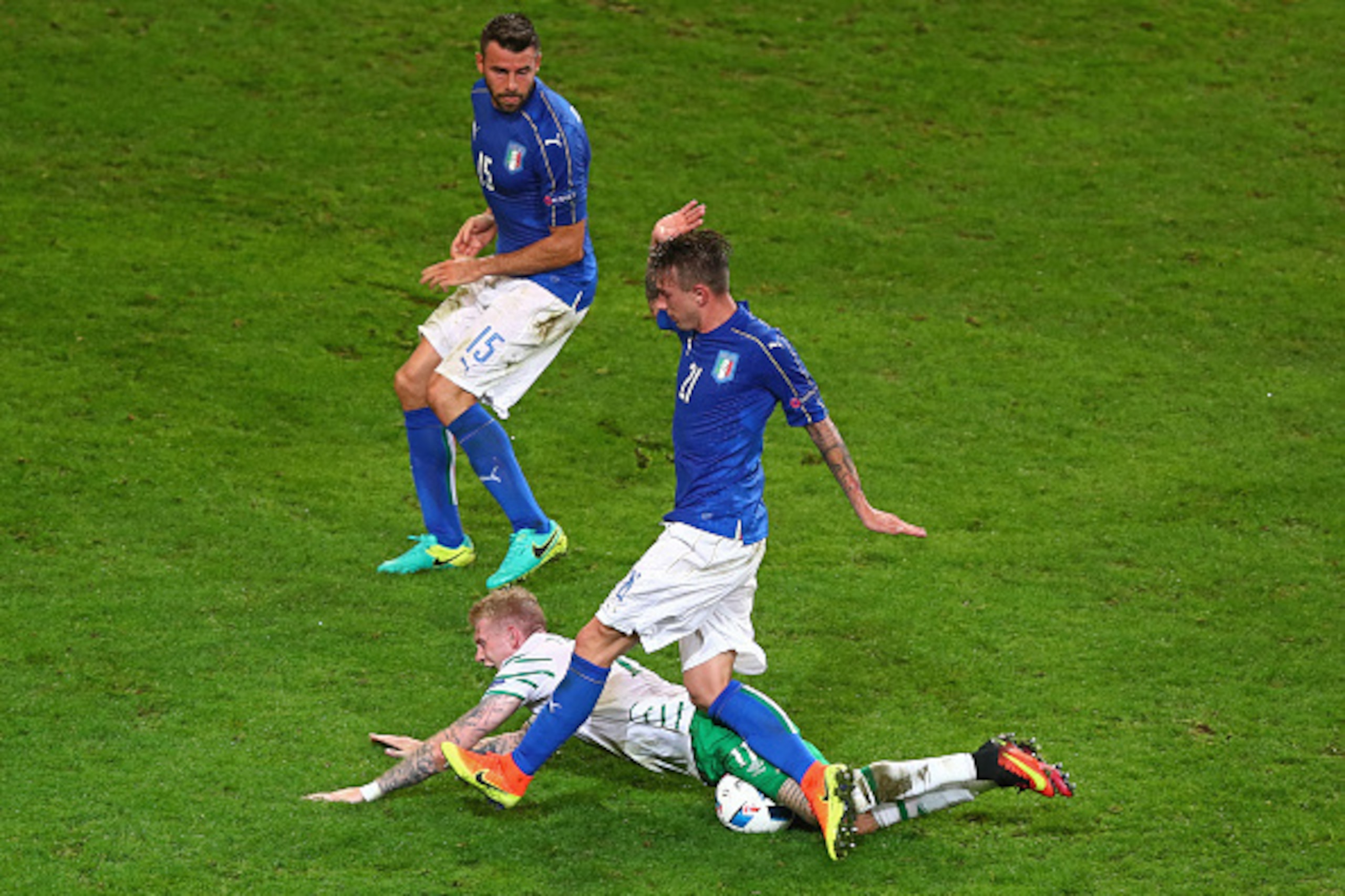 LILLE, FRANCE - JUNE 22: James McClean of Republic of Ireland is challenged by Federico Bernardeschi of Italy in the penalty area during the UEFA EURO 2016 Group E match between Italy and Republic of Ireland at Stade Pierre-Mauroy on June 22, 2016 in Lil LILLE, FRANCE - JUNE 22: James McClean of Republic of Ireland is challenged by Federico Bernardeschi of Italy in the penalty area during the UEFA EURO 2016 Group E match between Italy and Republic of Ireland at Stade Pierre-Mauroy on June 22, 2016 in Lil
