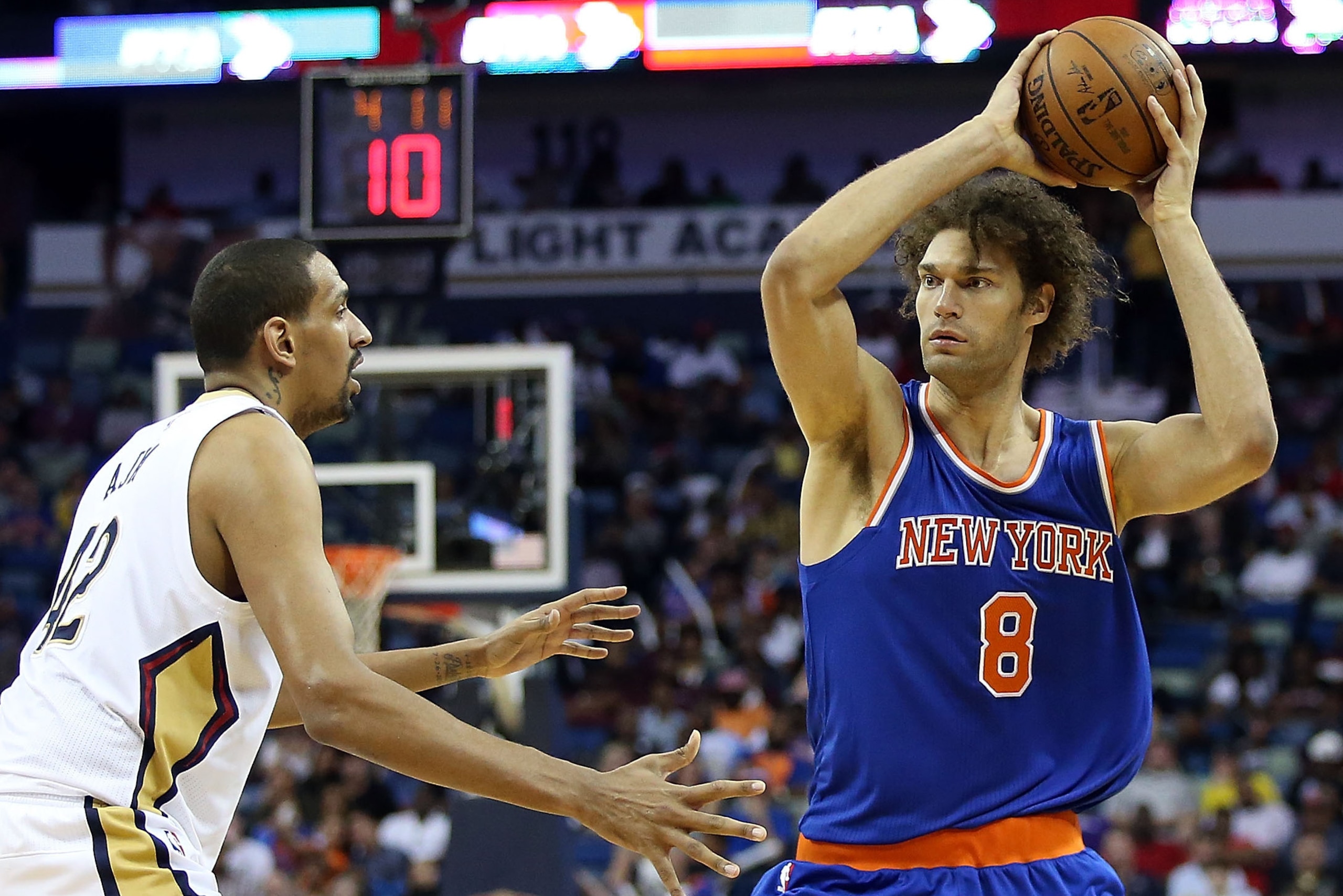 NEW ORLEANS, LA - MARCH 28:  Robin Lopez #8 of the New York Knicks looks to pass around Alexis Ajinca #42 of the New Orleans Pelicans during the second half at the Smoothie King Center on March 28, 2016 in New Orleans, Louisiana. NOTE TO USER: User expres