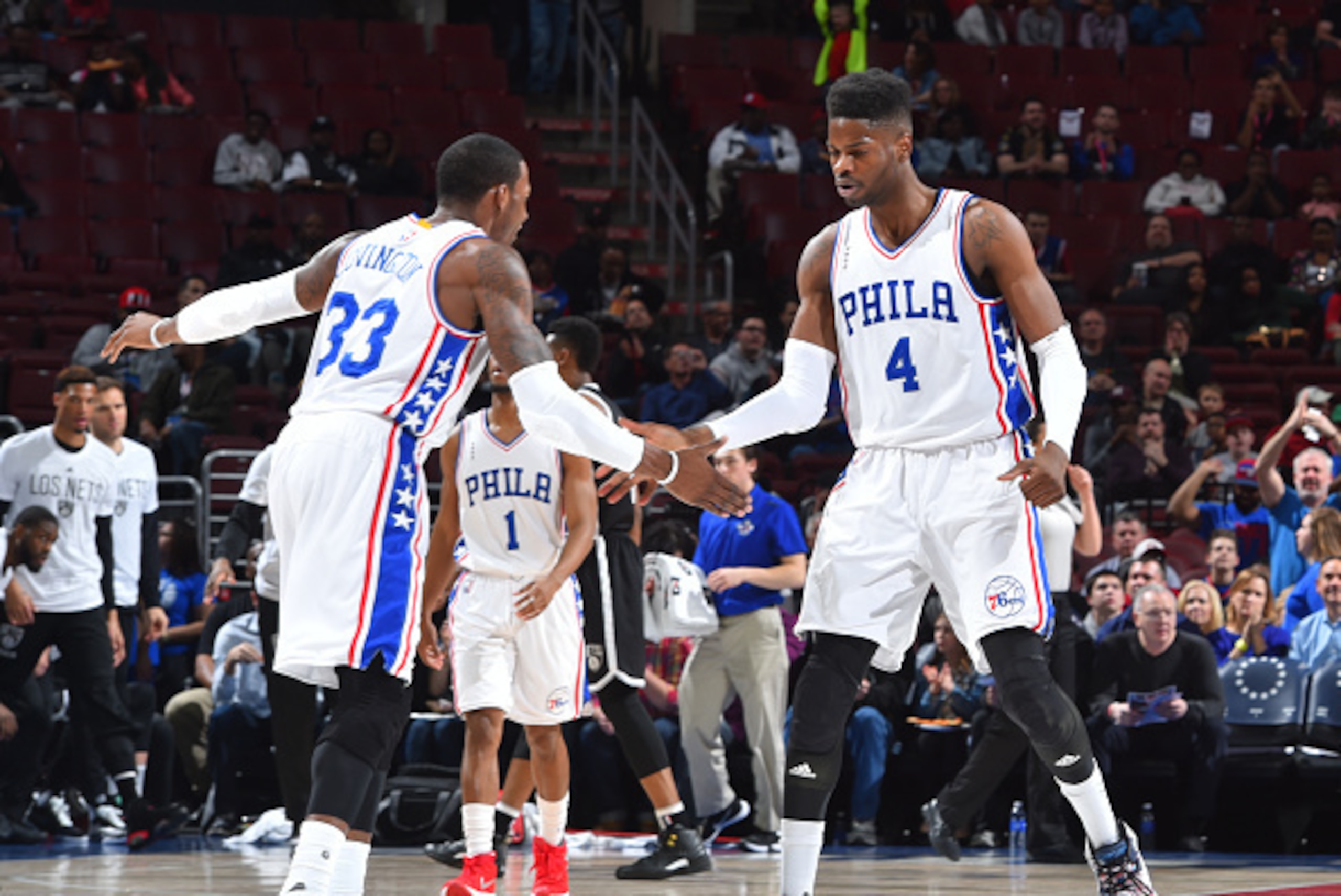 PHILADELPHIA,PA - MARCH 11:  Nerlens Noel #4 and Robert Covington #33 of the Philadelphia 76ers dap up against the Brooklyn Nets at Wells Fargo Center on March 11, 2016 in Philadelphia, Pennsylvania NOTE TO USER: User expressly acknowledges and agrees tha