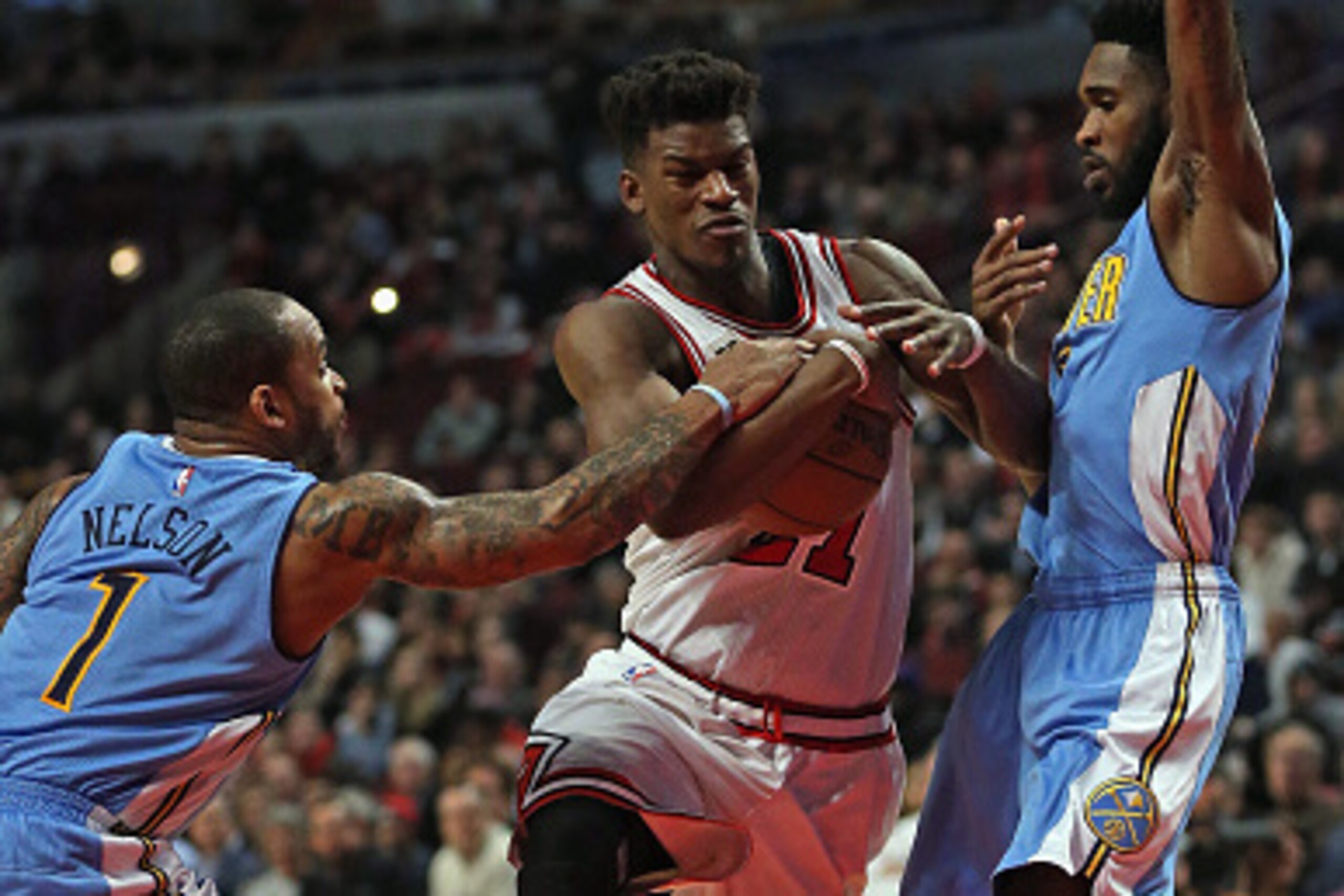 CHICAGO, IL - DECEMBER 02: Jimmy Butler #21 of the Chicago Bulls drives between Jameer Nelson #1 and Will Barton #5 of the Denver Nuggets at the United Center on December 2, 2015 in Chicago, Illinois. The Bulls defeated the Nuggets 99-90. Note to User: Us